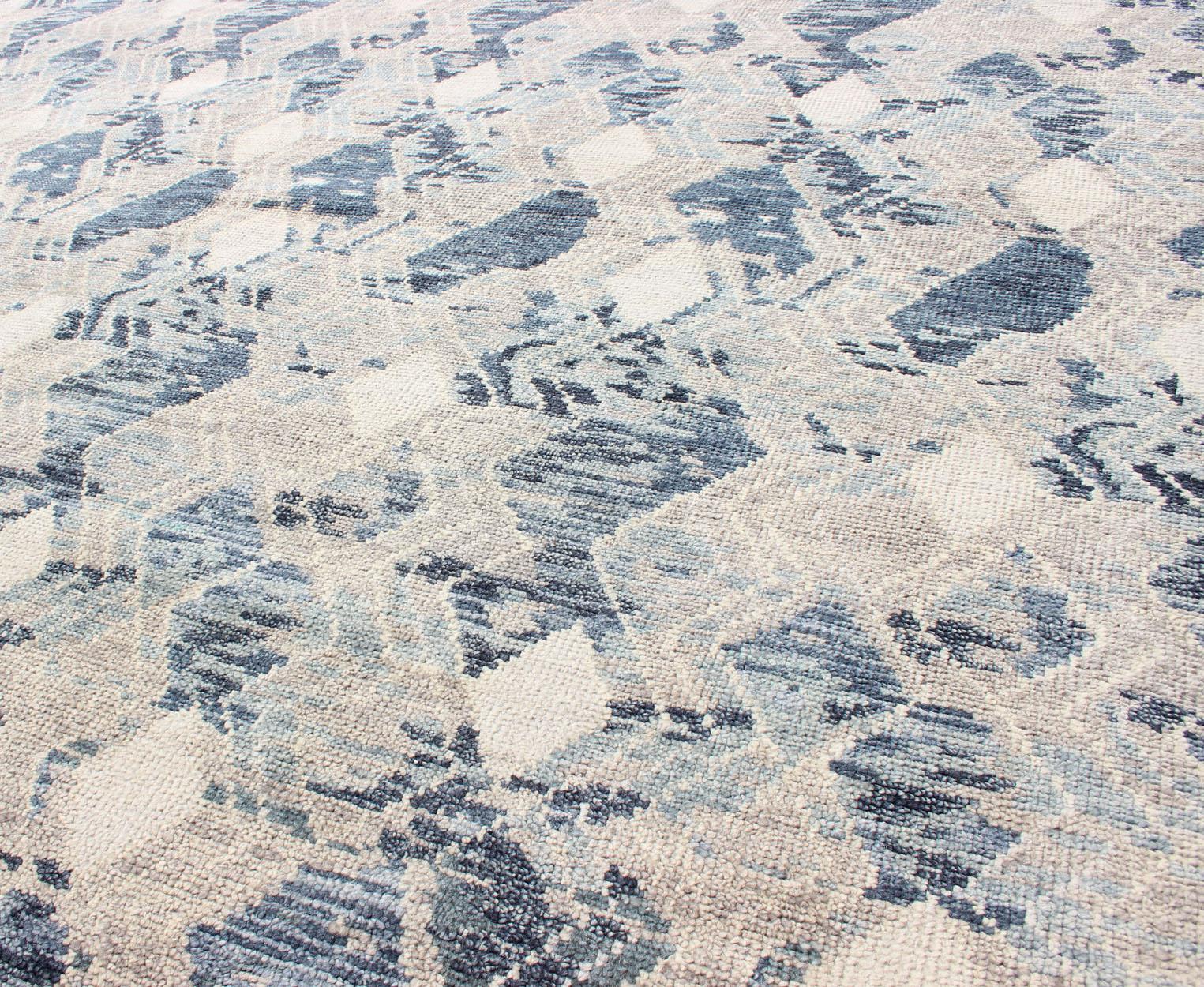 Modern Hand Knotted Rug by Keivan Woven Arts in Blue, Taupe & Off White 

Measures 9'0 x 12'0 

This beautiful hand woven rug, by Keivan Woven Arts arts, was hand-knotted in during 2010s. Common with modern made rugs, this piece features no borders