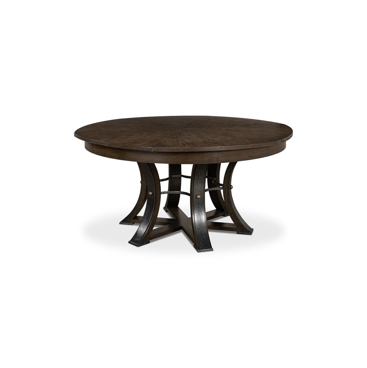 A modern industrial style round extending dining room table. Wire brushed oak top in our wire brushed oak finish with gunmetal iron accents to the simple geometric form base. The table opens and extends to 84