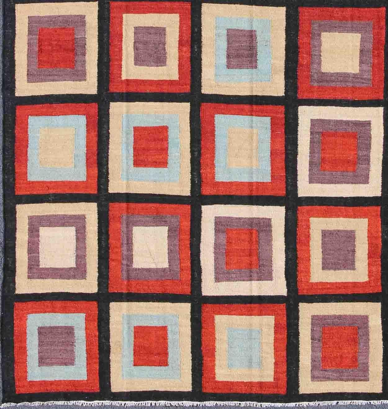 Afghanistan made Kilim Rug with multicolored boxed design in red, blue, cream, purple, rug mp-888, country of origin / type: Afghanistan / Kilim, circa 1980

This vibrant Afghan Kilim rug displays a large checkerboard design of boxed shapes.