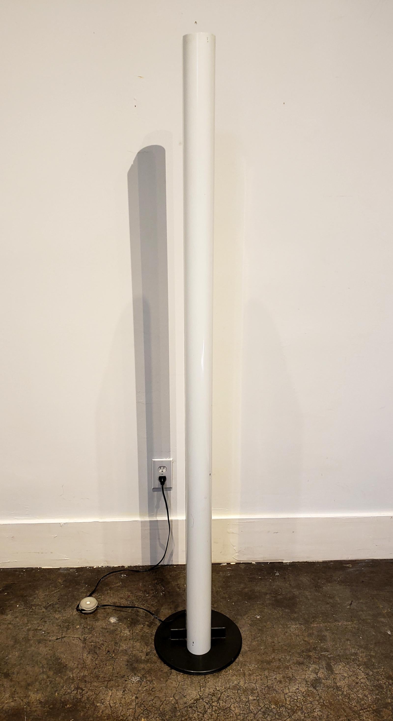 Tall, white, enameled steel floor lamp designed and manufactured in Italy, circa 1980. Oval shape with split down the middle, raised on black 12