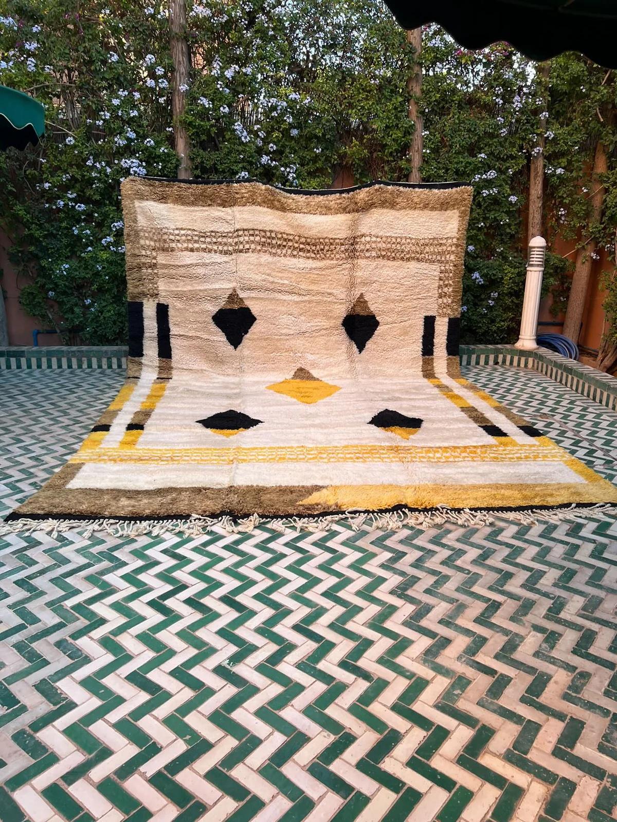 This large cream neutral handwoven Moroccan rug was made by hand by skilled artisans in the Atlas Mountains using the highest quality M'Rirt wool. It is impressive in both size and design, and is the perfect luxury statement piece for any room. A