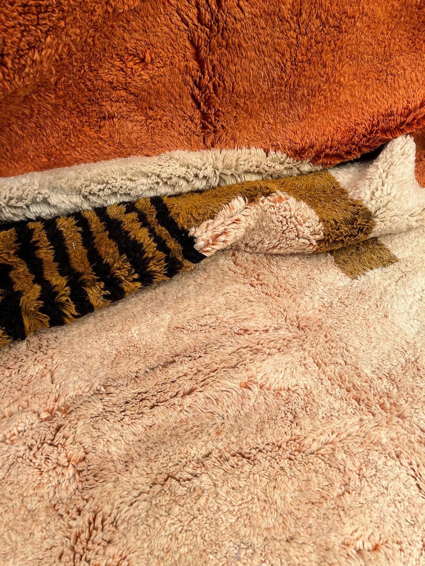 This large rich neutral handwoven Moroccan rug was made by hand by skilled artisans in the Atlas Mountains using the highest quality M'Rirt wool. It is impressive in both size and design, and is the perfect luxury statement piece for any room. Warm