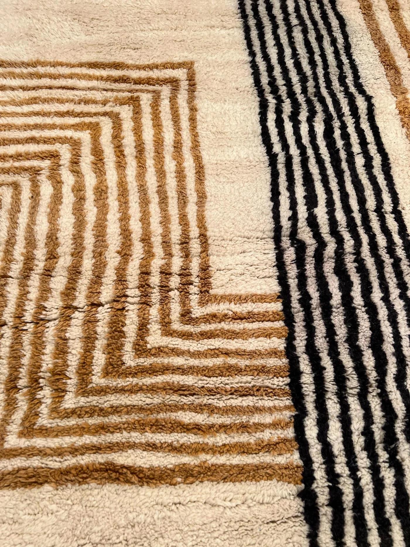 This large cream neutral handwoven Moroccan rug was made by hand by skilled artisans in the Atlas Mountains using the highest quality M'Rirt wool. It is impressive in both size and design, and is the perfect luxury statement piece for any room. A