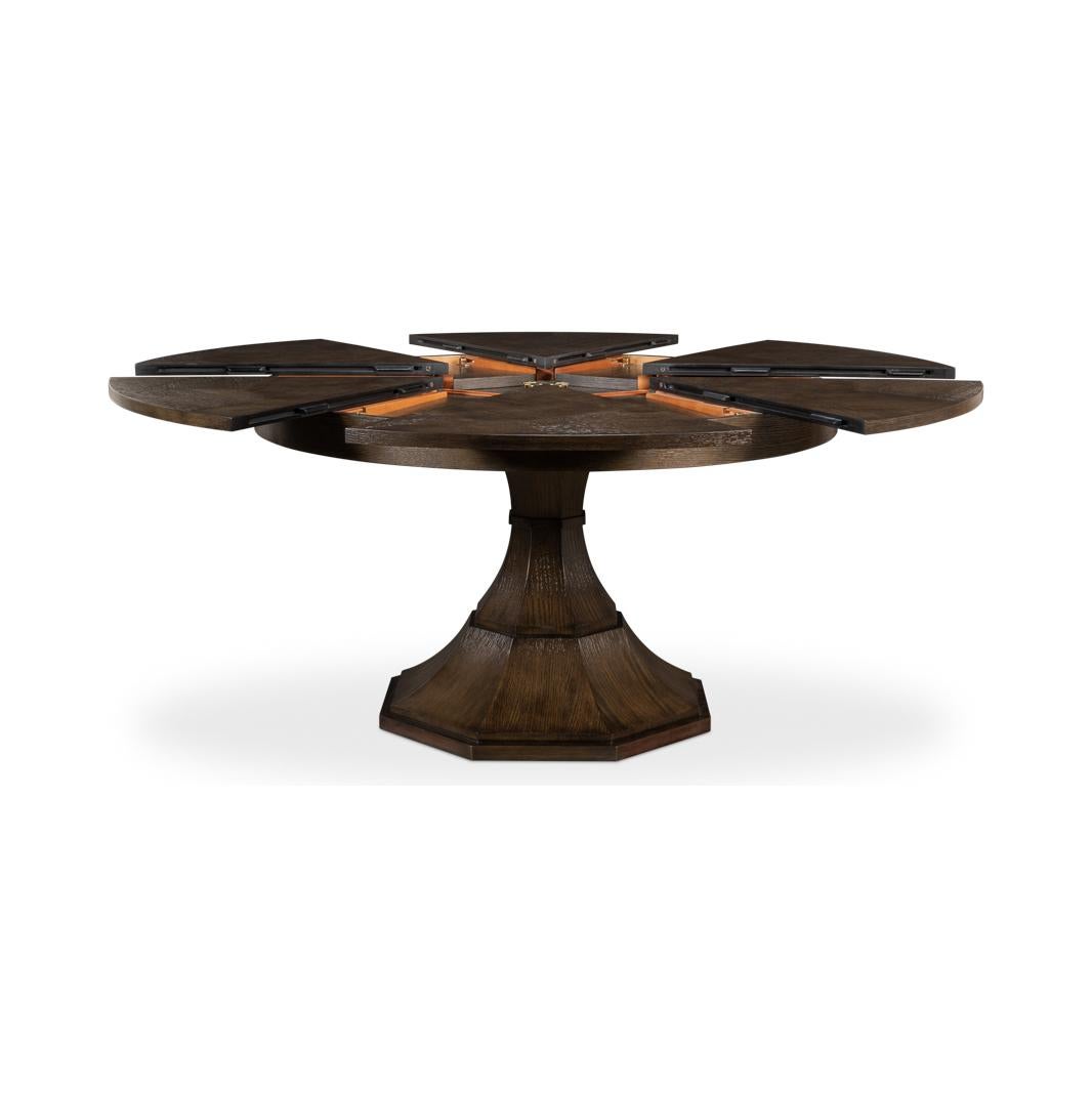 A remarkable piece that blends contemporary design with functional innovation. This modern round table is veneered in oak with the artisan-grey medium brown finish, bringing a rich and sophisticated aura to any dining space.

The genius of this
