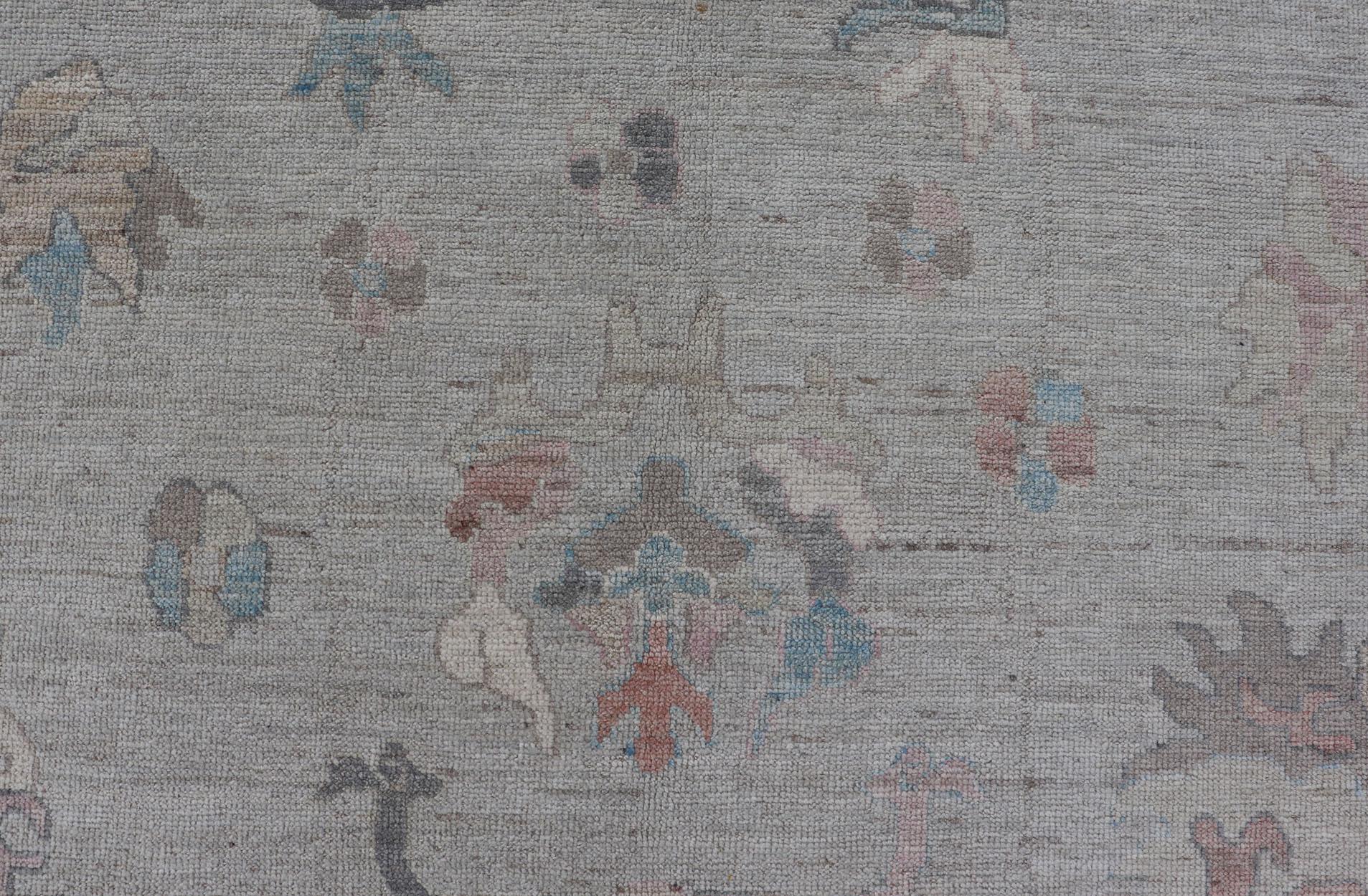 Hand-Knotted Large Oushak Rug with Floral Motifs & Muted Colorful Tones on Neutral Background For Sale