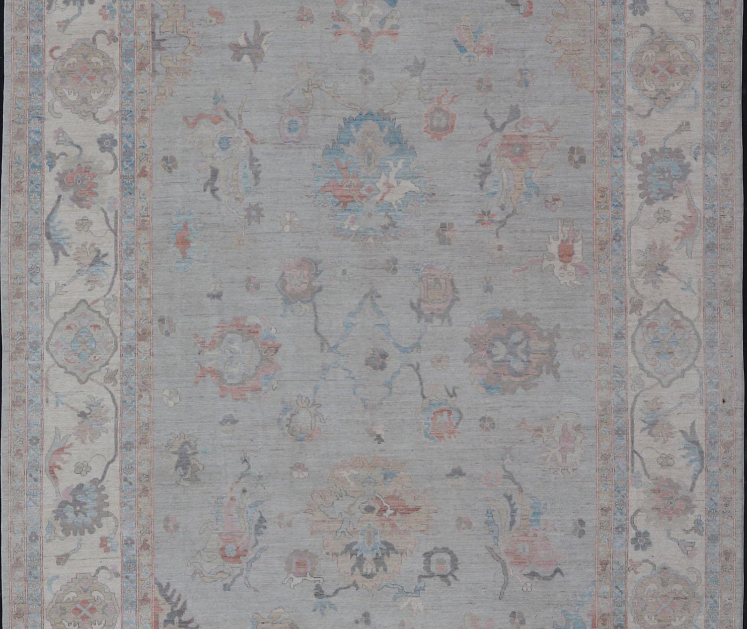 Wool Large Oushak Rug with Floral Motifs & Muted Colorful Tones on Neutral Background For Sale