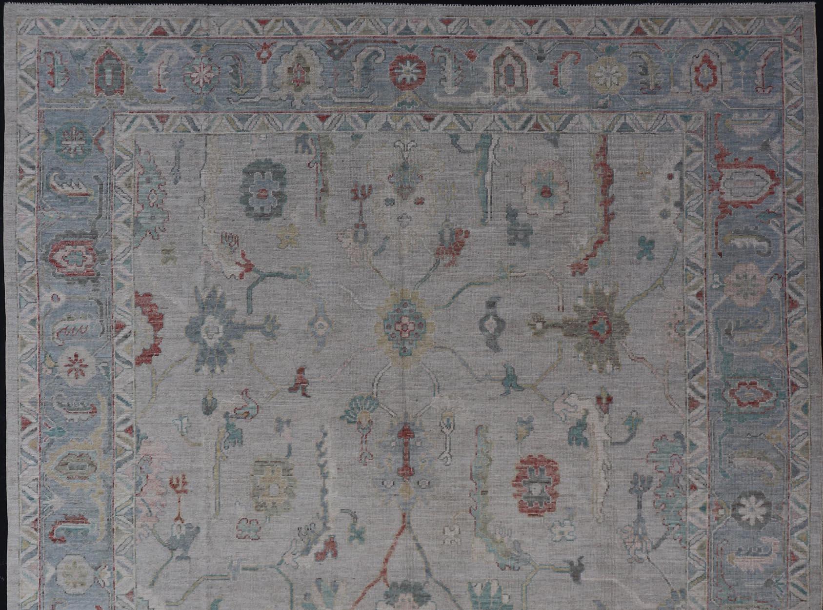 Afghan Large Modern Oushak With Floral Design on Light Blue Border With Pop of Colors For Sale
