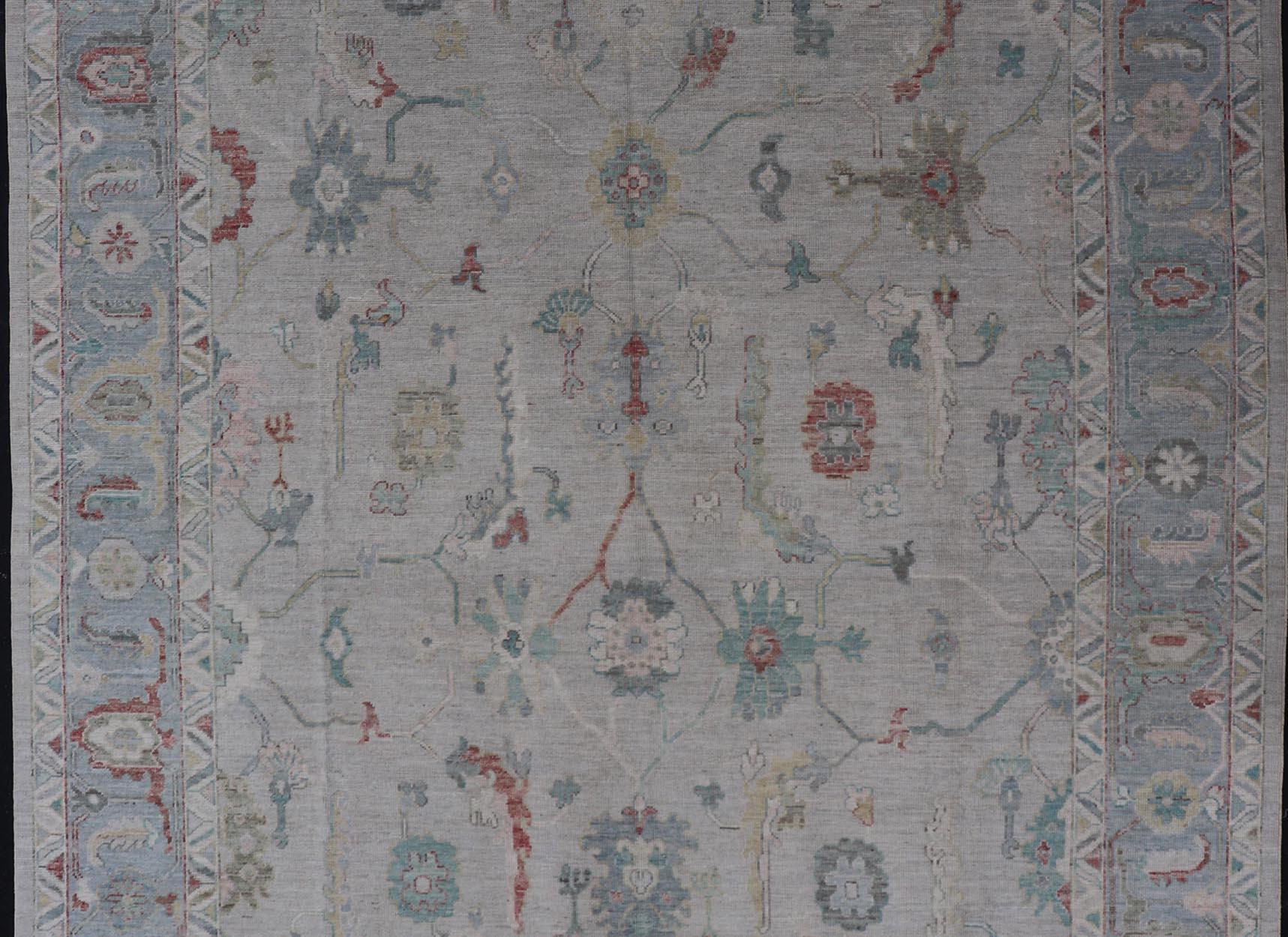 Hand-Knotted Large Modern Oushak With Floral Design on Light Blue Border With Pop of Colors For Sale