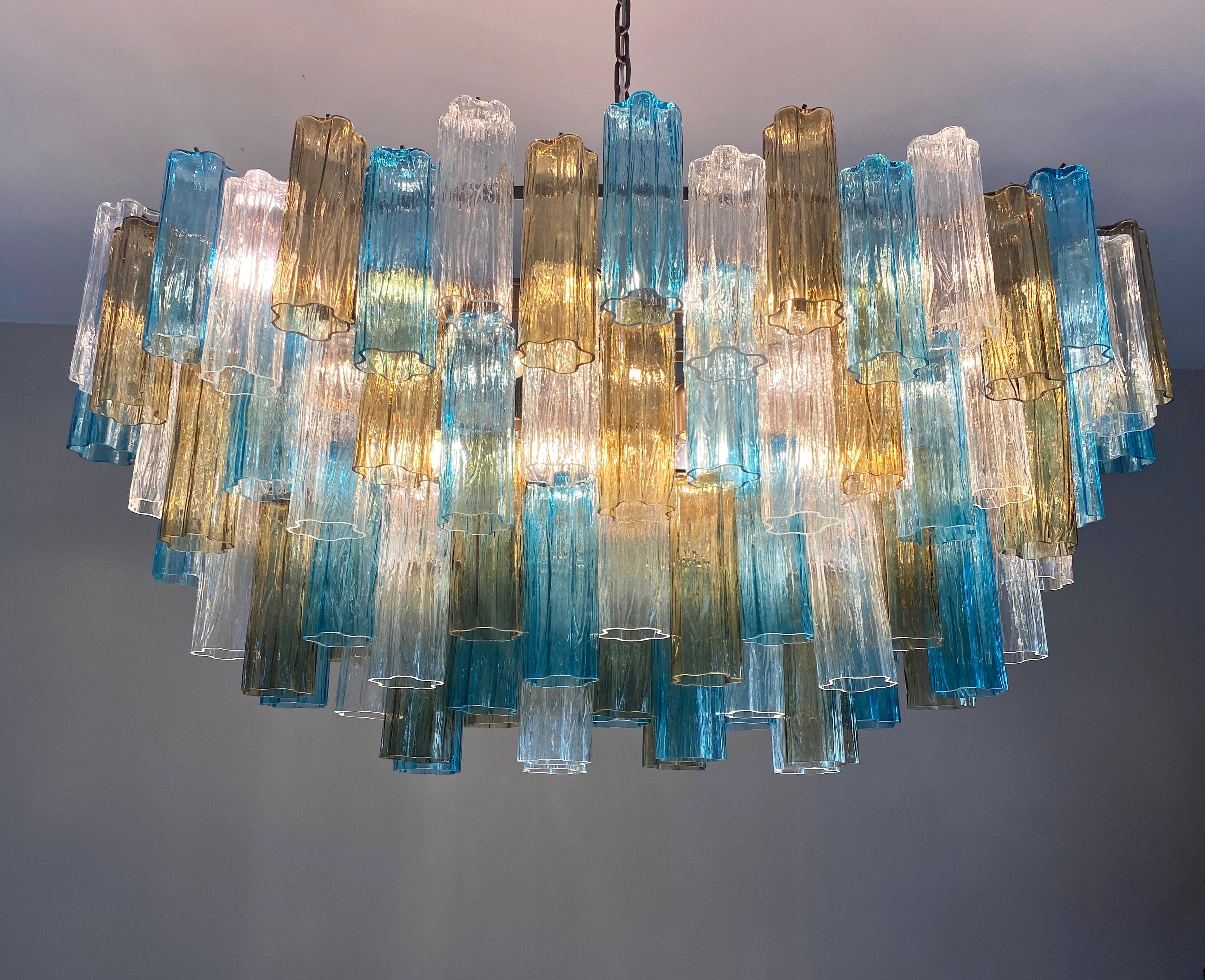 Outstanding Murano chandelier made by Murano crystal multicolored tronchi on  four  levels with a patinated bronze color metal frame.
The glasses are blu , clear and smoky, creating a fabulous light effect.
 We can customize tho combination of the