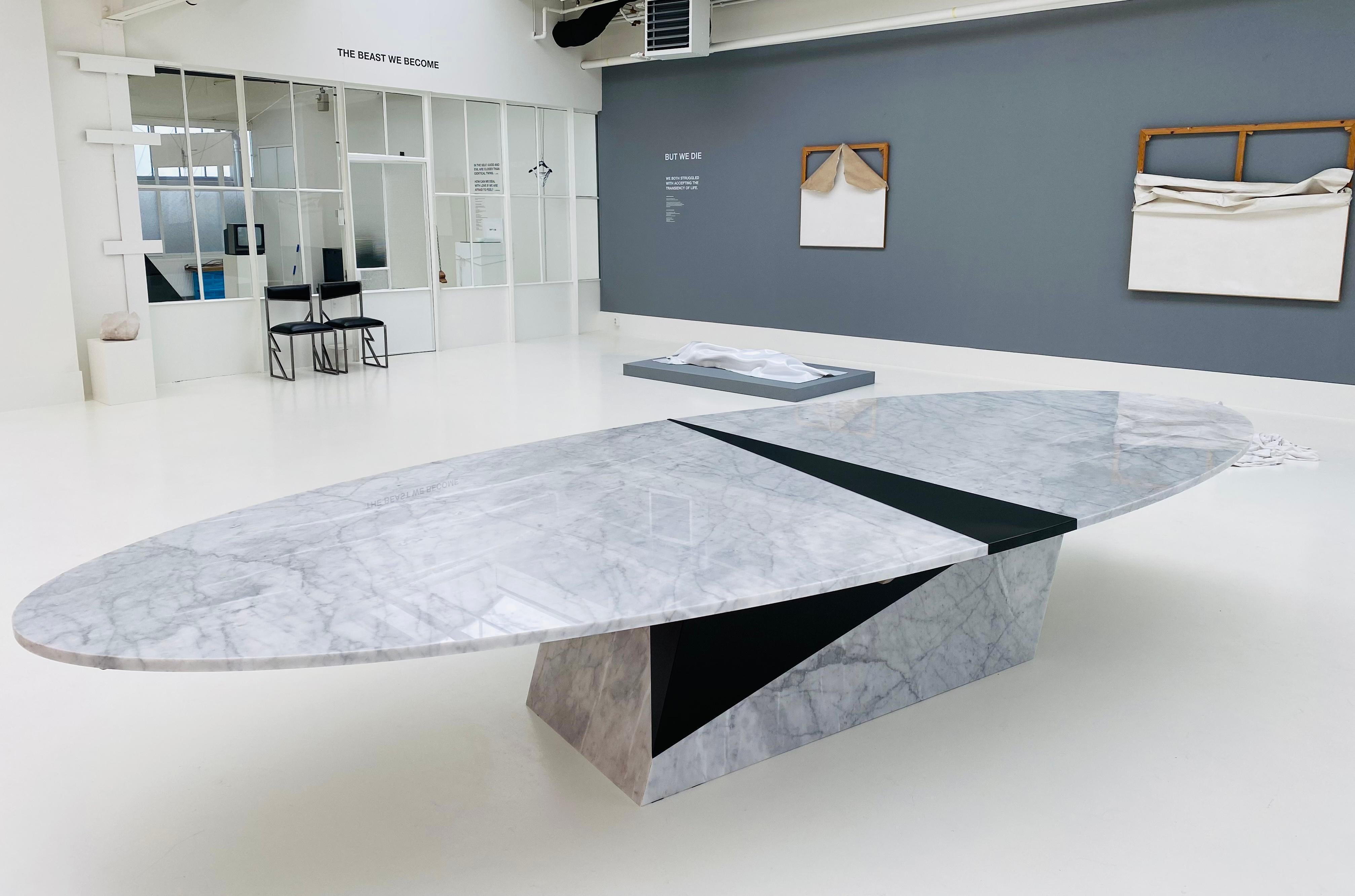 This large collectible design oval conference table or dining table is made of approximately 1000 kg Carrara marble. It is designed by female artist / designer Roos Schneijderberg and called THE SIZE DOES MATTER. It is an impressive, yet