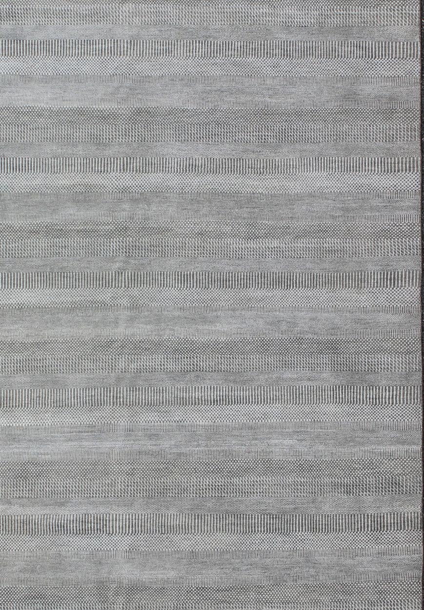 Large rug Transitional modern rug in shades of grey and ivory with small repeating design. Keivan Woven Arts /origin/ India Circa / 2010 IN-KAS-8166

Measures: 12'9 x 20'0.

This fine hand-woven Modern Transitional rug features a beautiful