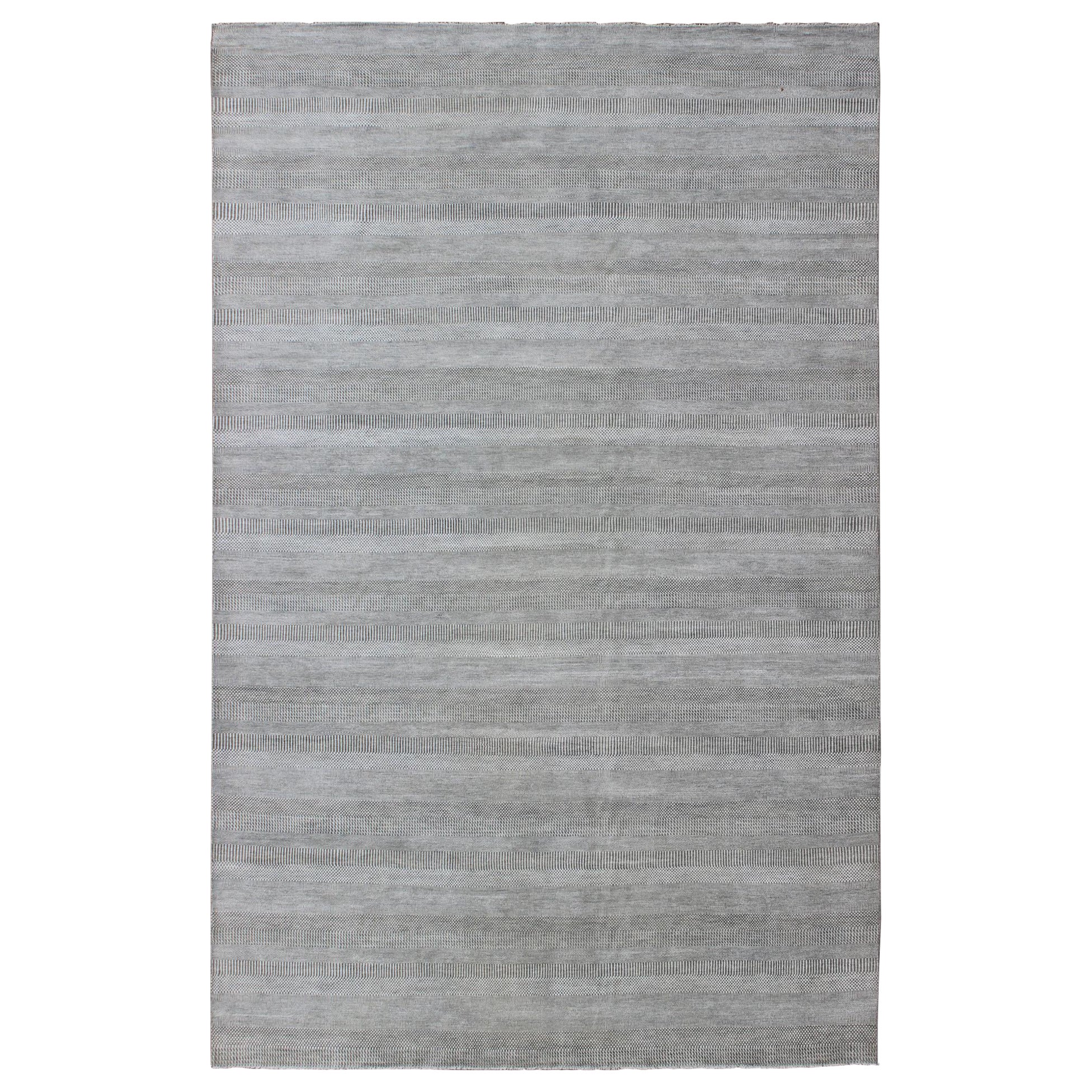 Tappeto moderno di grandi dimensioni con un design di transizione nei toni del grigio e dell'avorio