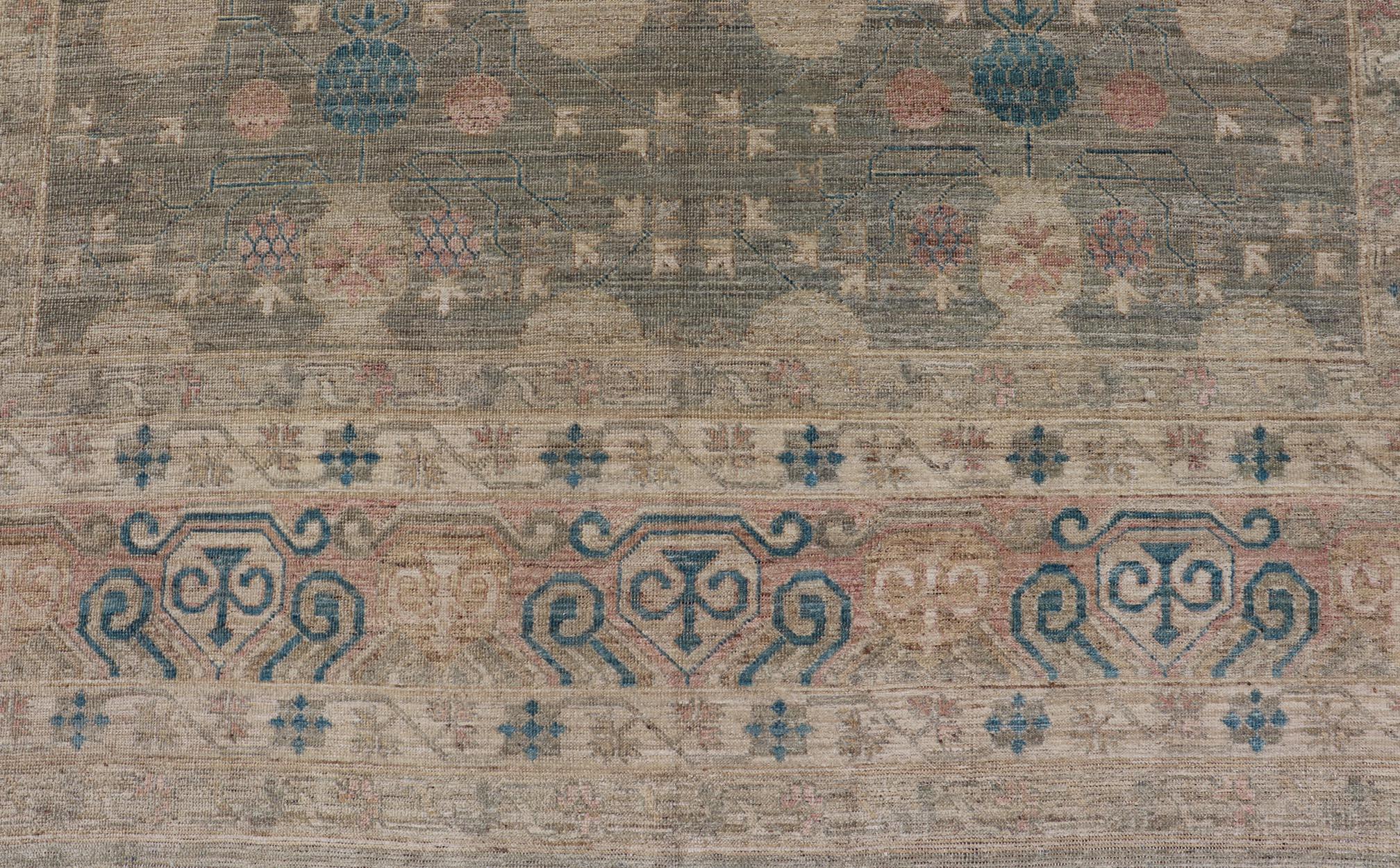 Large Modern Tribal Khotan Rug in Shades of Cream, Green, Blue, and Coral. Keivan Woven Arts Country of origin; Afghanistan Type: Khotan Keivan Woven Arts; rug AWR-17257, early 21st century. 
Measures: 10'5 x 13'8 
This modern Khotan features a