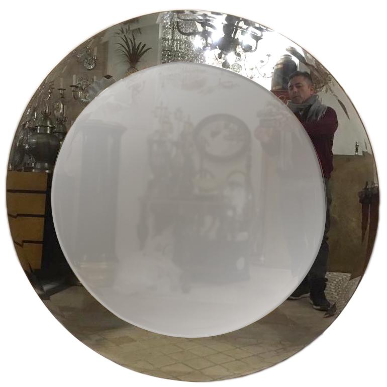 A circa 1960s Italian Moderne style round mirror with smoke colored glass frame.

Measurements:
Diameter 48