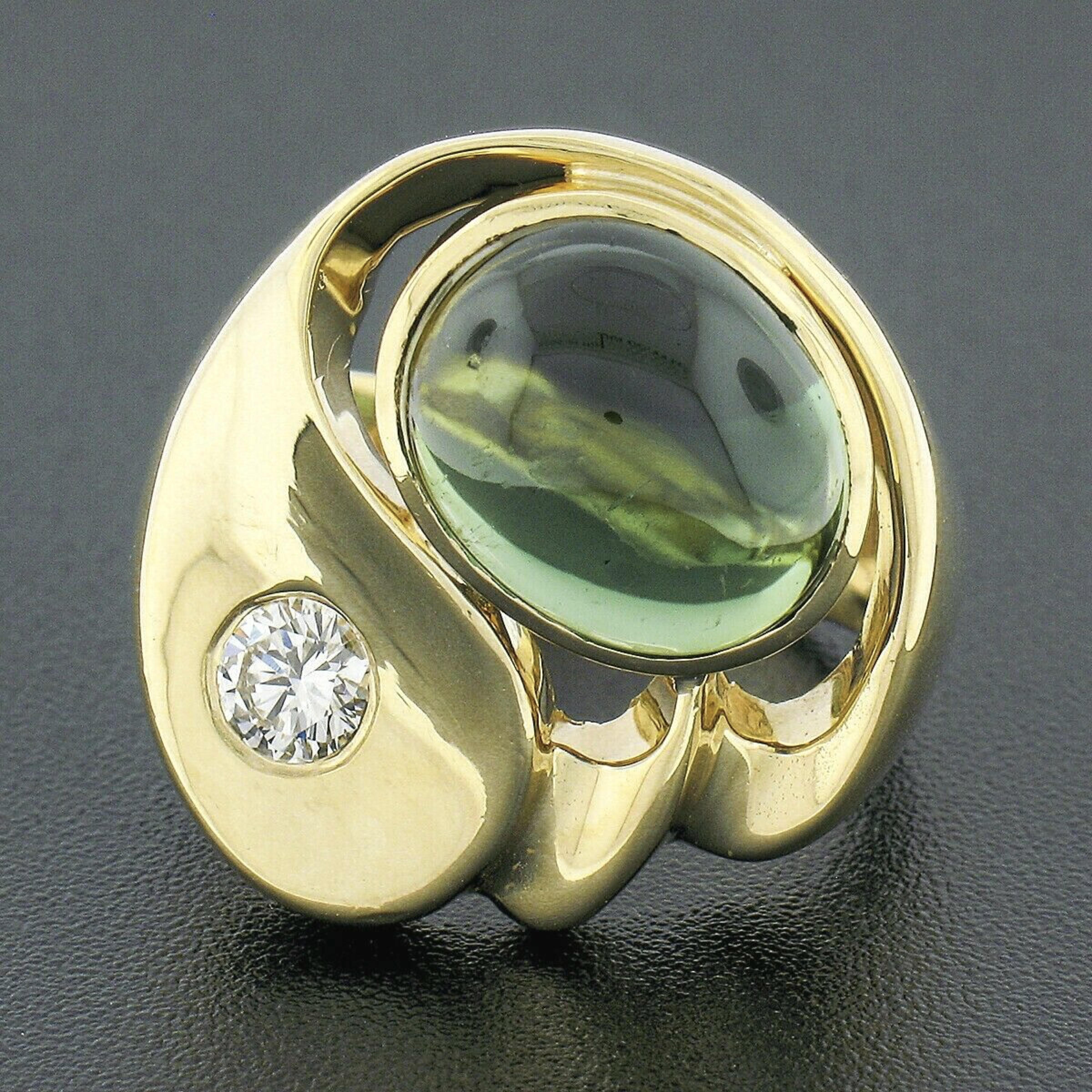 Here we have a beautiful modernist ring crafted in solid 18k yellow gold. This large ring features an oval cabochon cut tourmaline neatly bezel set in open work and displays a very fine and rich green color that brings a truly desirable look to this