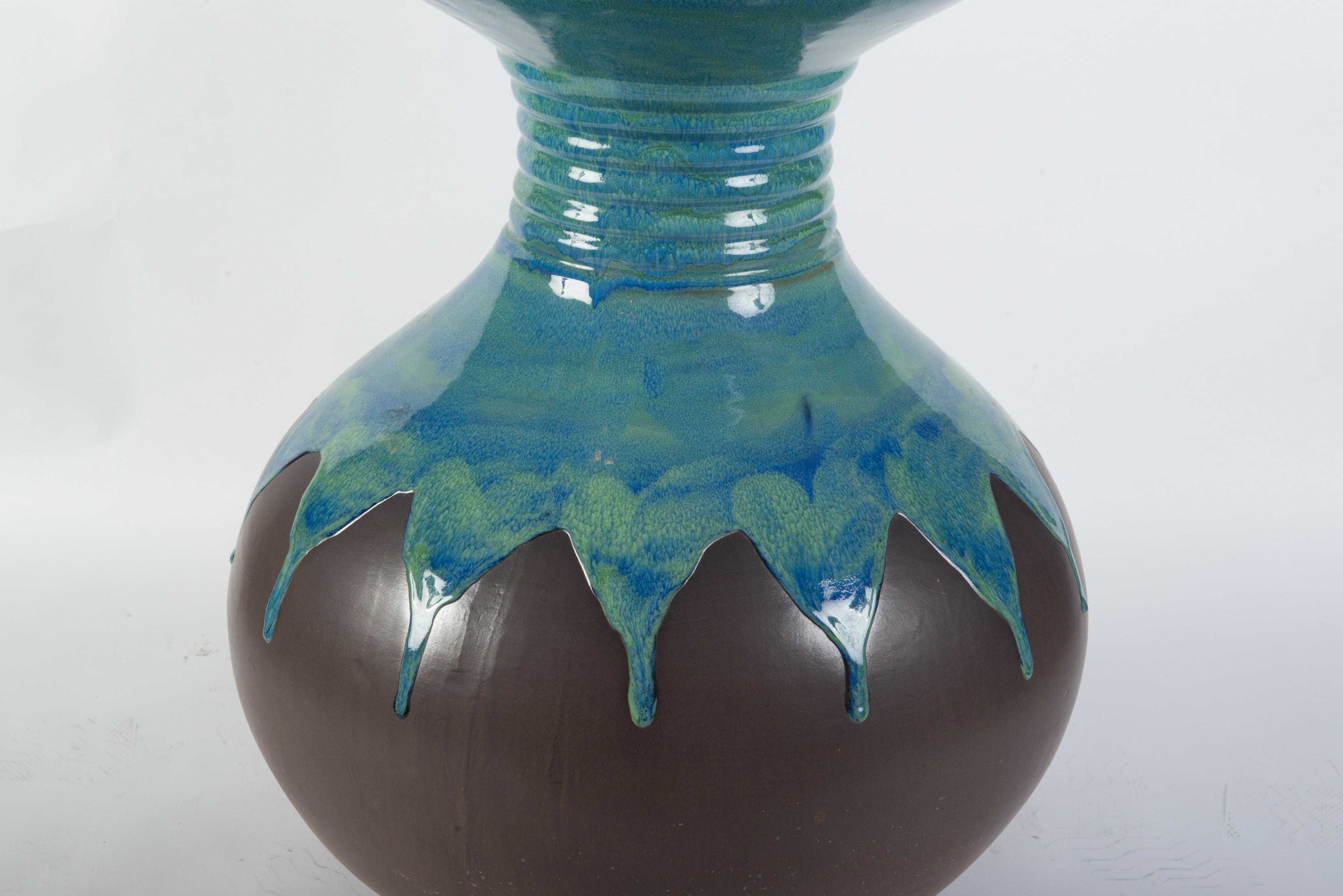 Large pottery vase with turquoise glaze and brown matte finish.