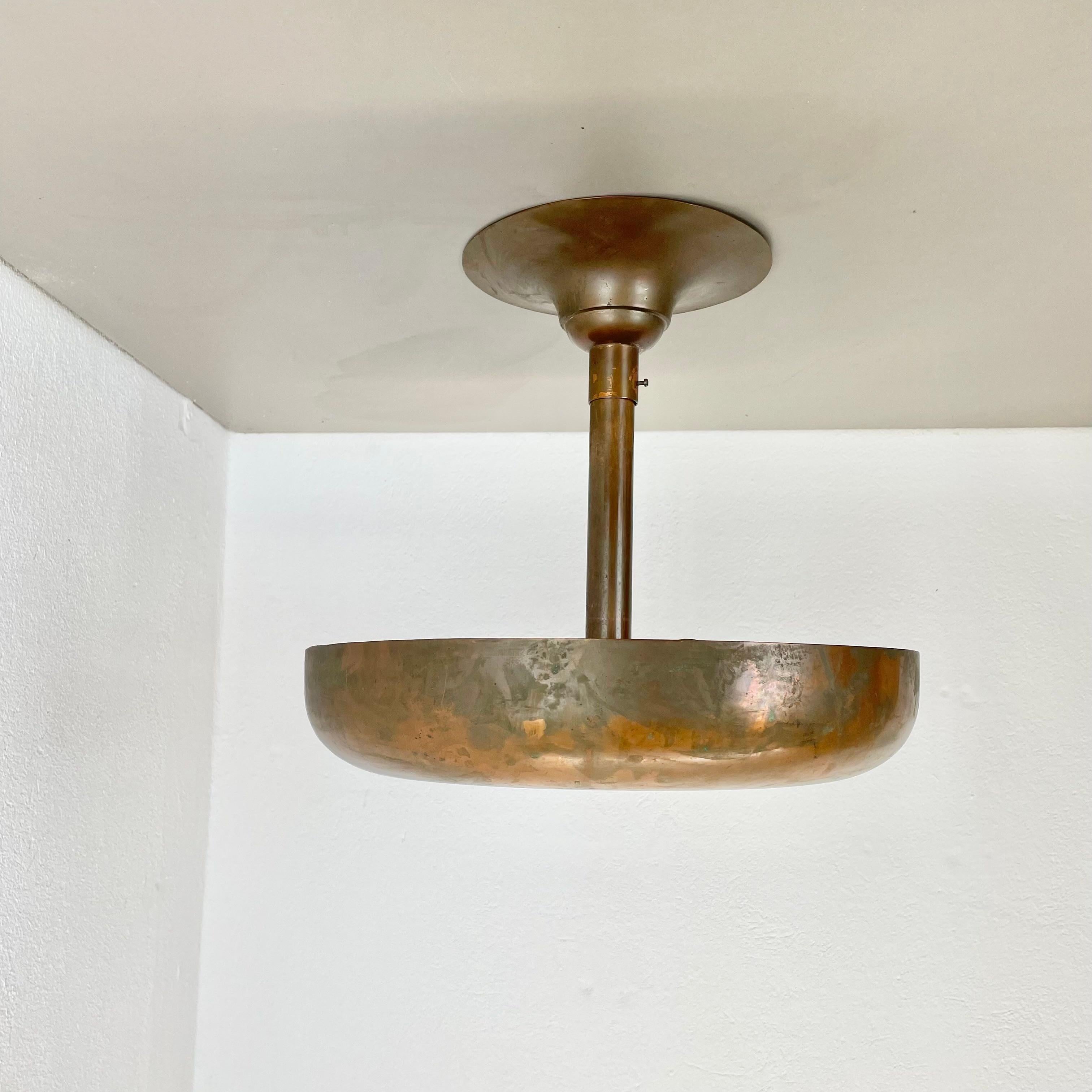 Article:

large ceiling uplight element


Origin:

France



Age:

1920s, 1930s





Original modernist art deco ceiling light made of solid copper. the light features a large round shade element made of solid copper with a diameter of 37cm. the