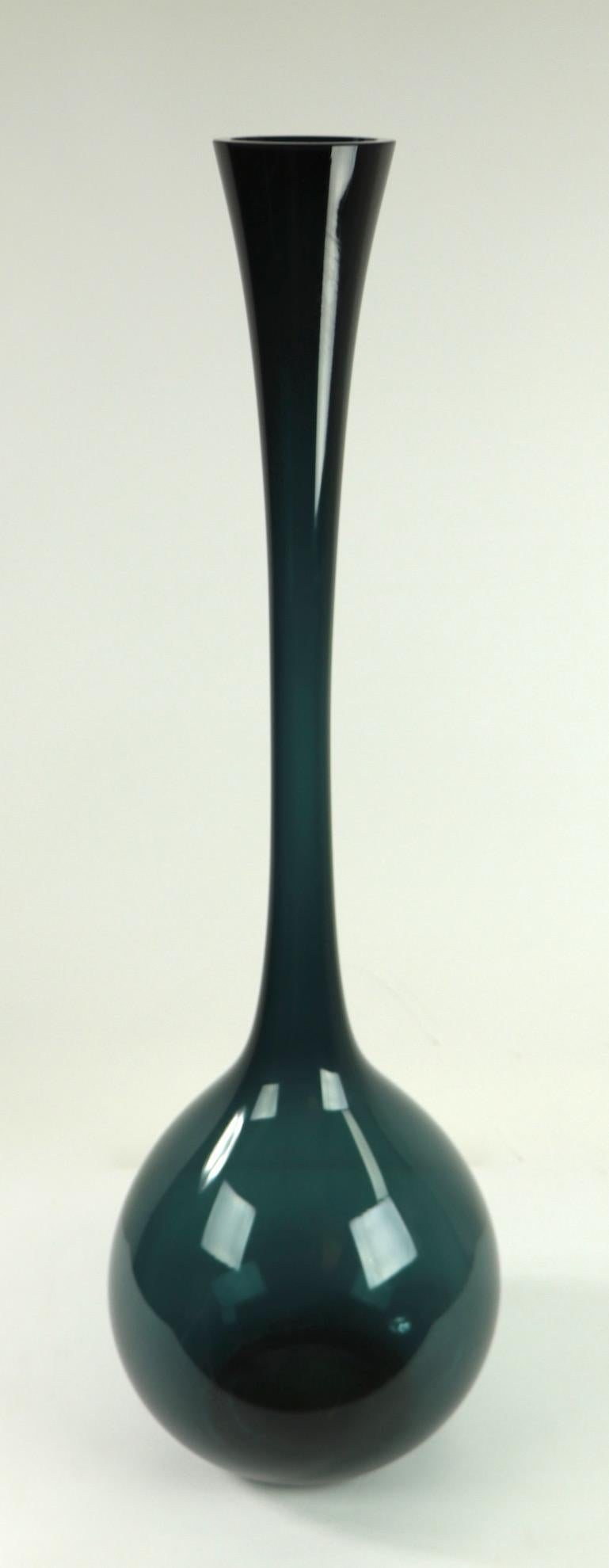 Elegant elongated midcentury art glass vase having a tall trumpet form neck, and bulbous base. Probably Blenko or possibly Italian or Swedish production. Incredible scale, intriguing color and great condition.