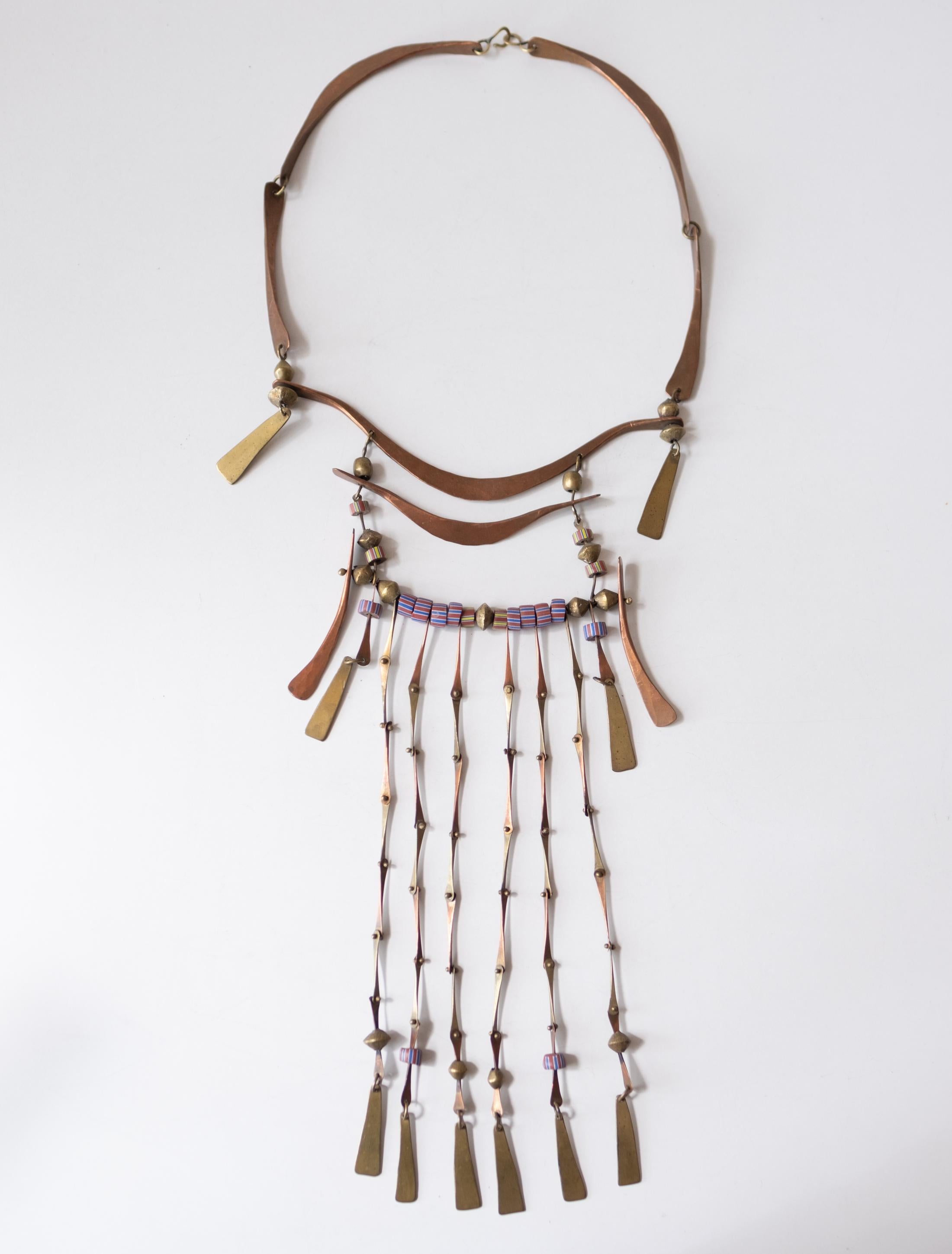 Large Modernist bronze wearable sculpture. The studio made necklace is from the 1970s. Finely crafted statement piece with glass beads incorporated with hand hammered bronze kinetic pieces. From the estate of a Tucson artist.   