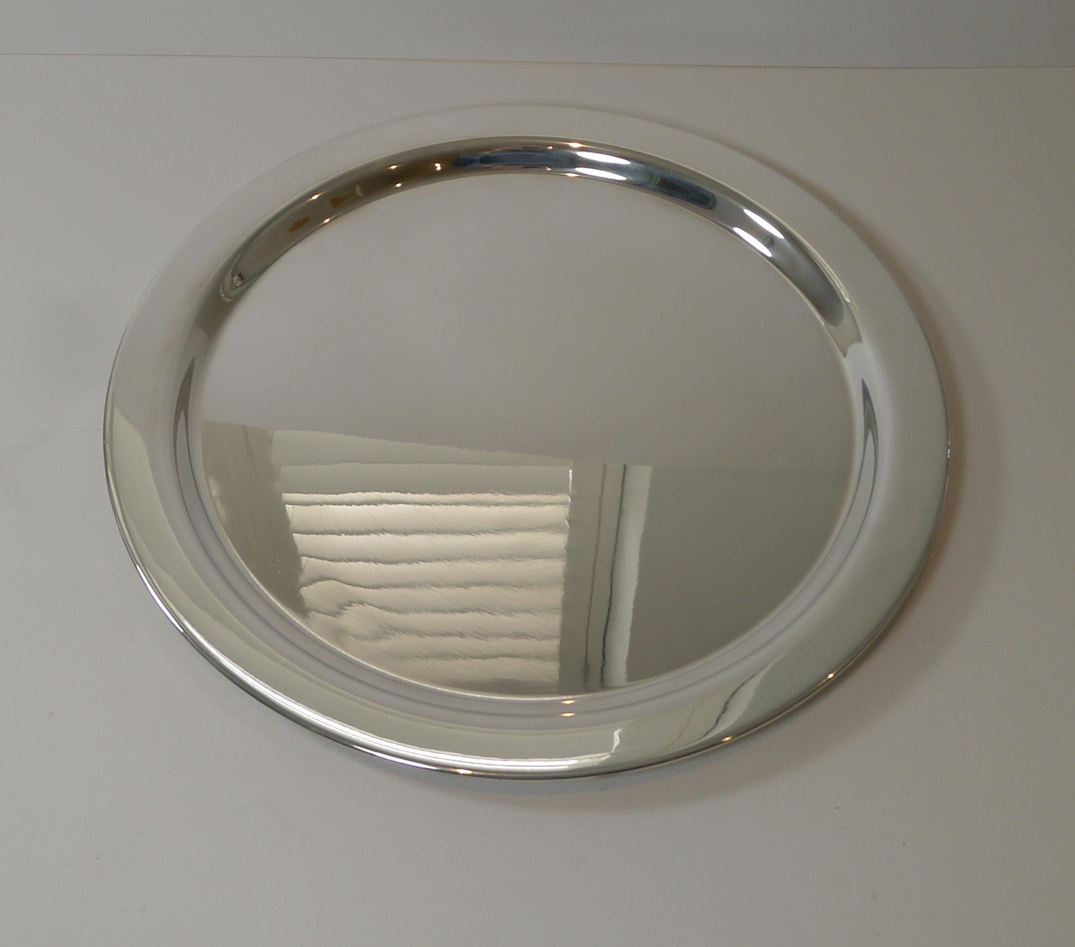 A simple, stylish and modernist circular silver plated tray signed on the underside by the Danish Company, Cohr.

Just back from our silversmith's workshop where it has been professionally cleaned and polished, restoring it to it's former