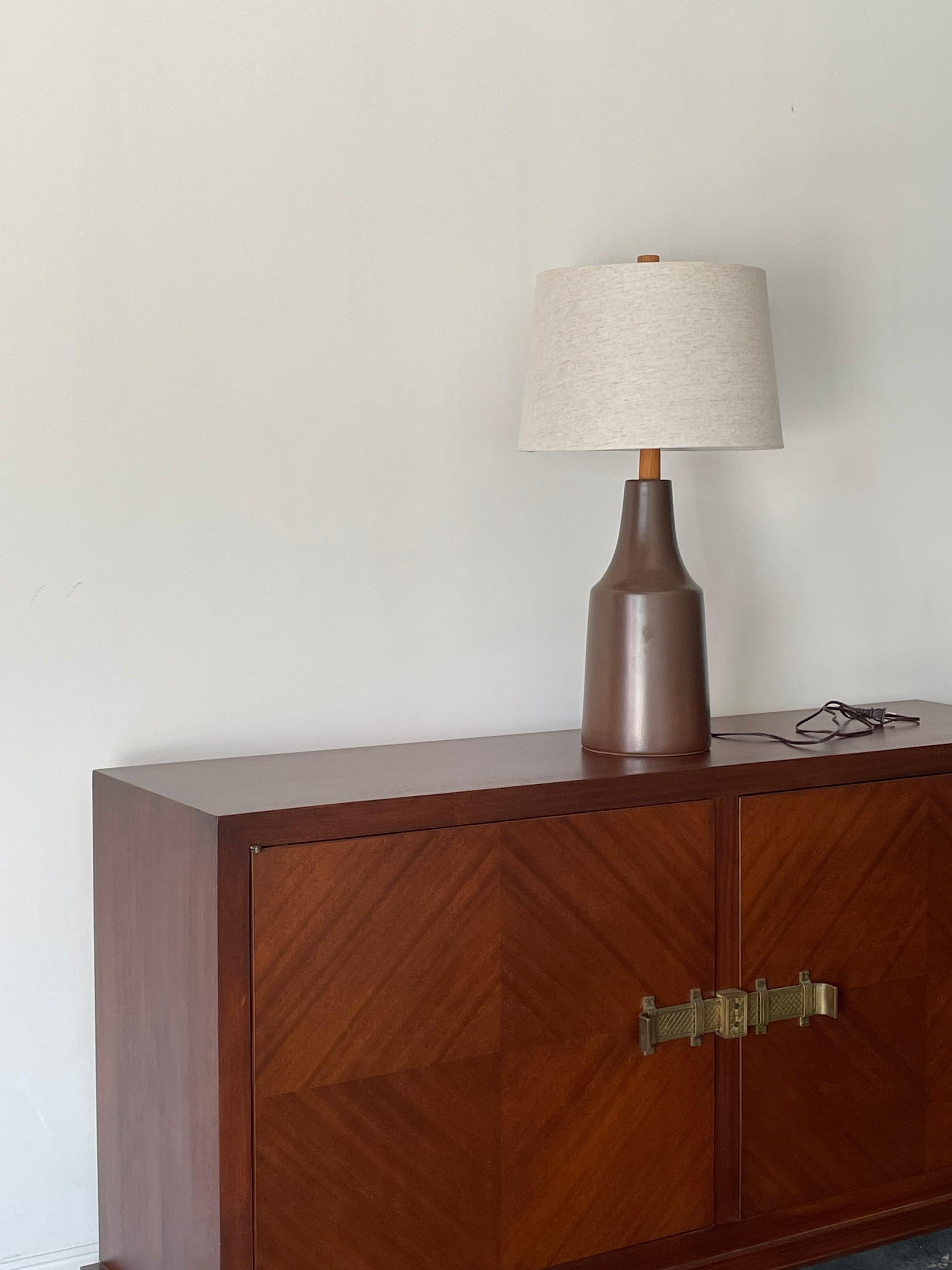 Large modernist ceramic table lamp designed by famed ceramicist duo Jane and Gordon Martz for Marshall Studios. Color is a dark brown with some amber tones present towards the bottom 

Measures: Overall
28” tall 
15” wide 

Ceramic 
15.5”