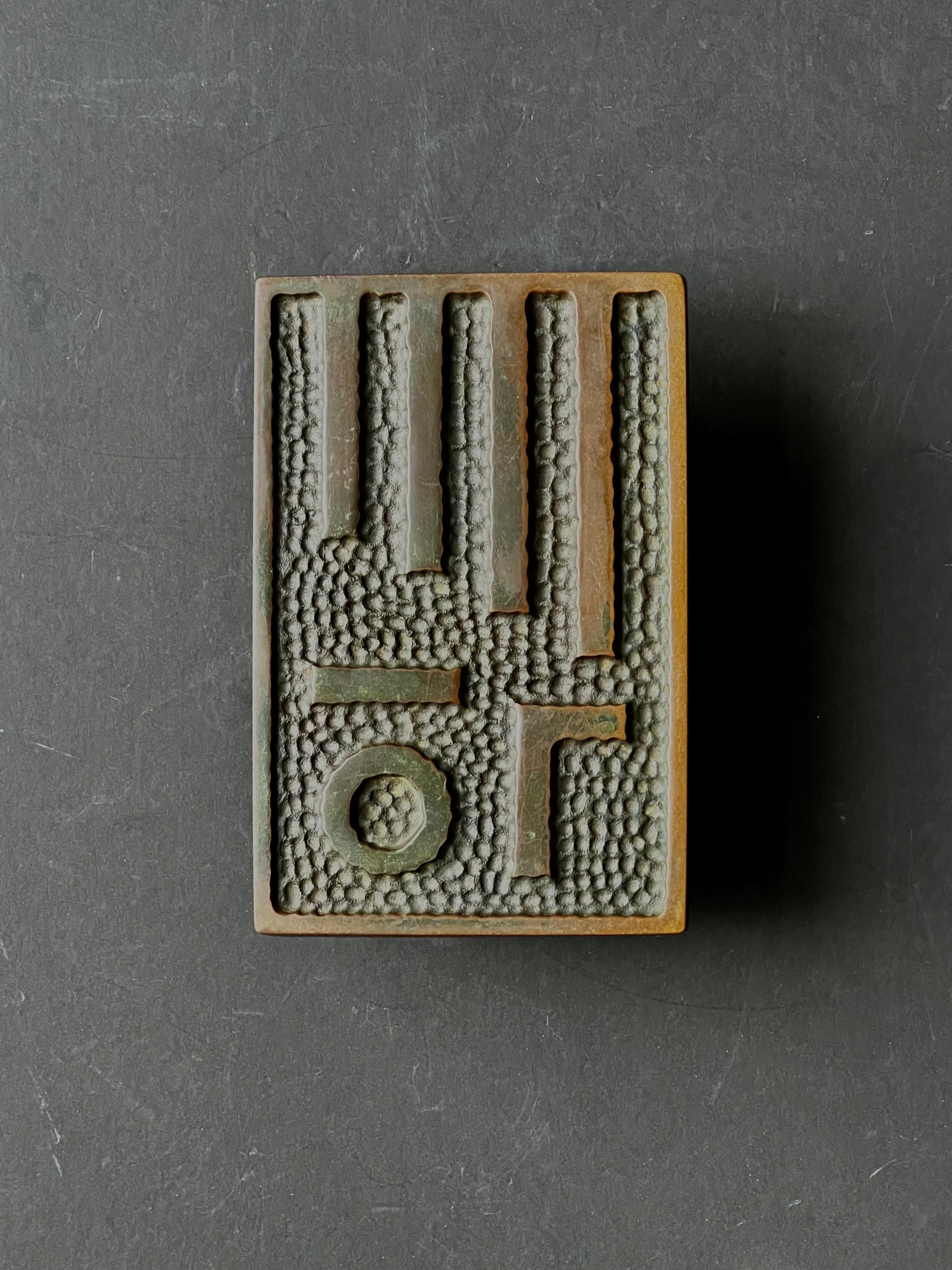 A large push-pull door handle of cast bronze with geometric modernist design. Found in Germany and dating from the third quarter 20th century.

The handle has been left as found, unpolished, and shows different tones from deep brown to rich