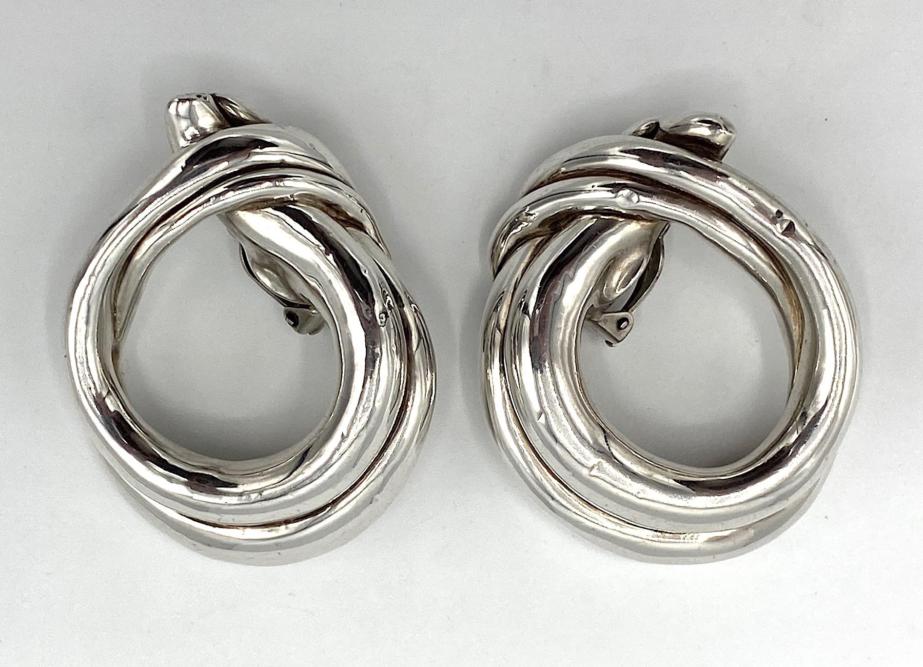 An elegant and large pair of 1980s modernist sterling silver earrings by modernist Israeli jewelry David Varsano. Each earrings is a double wide wrap loop of sterling silver 1.82 inches wide, 2.38 inches tall and .63 of an inch deep. Clip back and