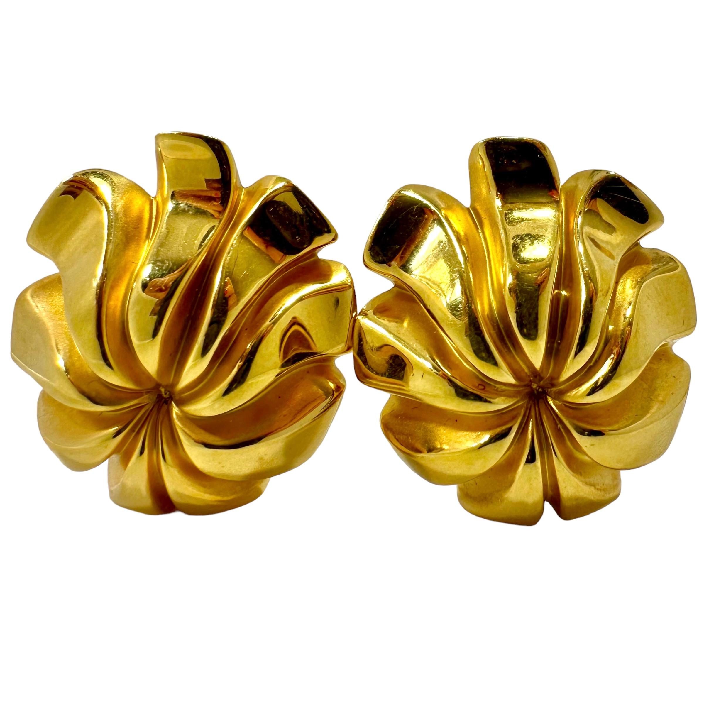 This outstanding pair of 18k yellow gold Tiffany & Co. earrings epitomize Tiffany style and quality with a modernist flair. Each measures 1 5/16 inches by 1 1/16 inches, and rises 1/2 inch above the ear, at the apex. Nine stylized petals on each are
