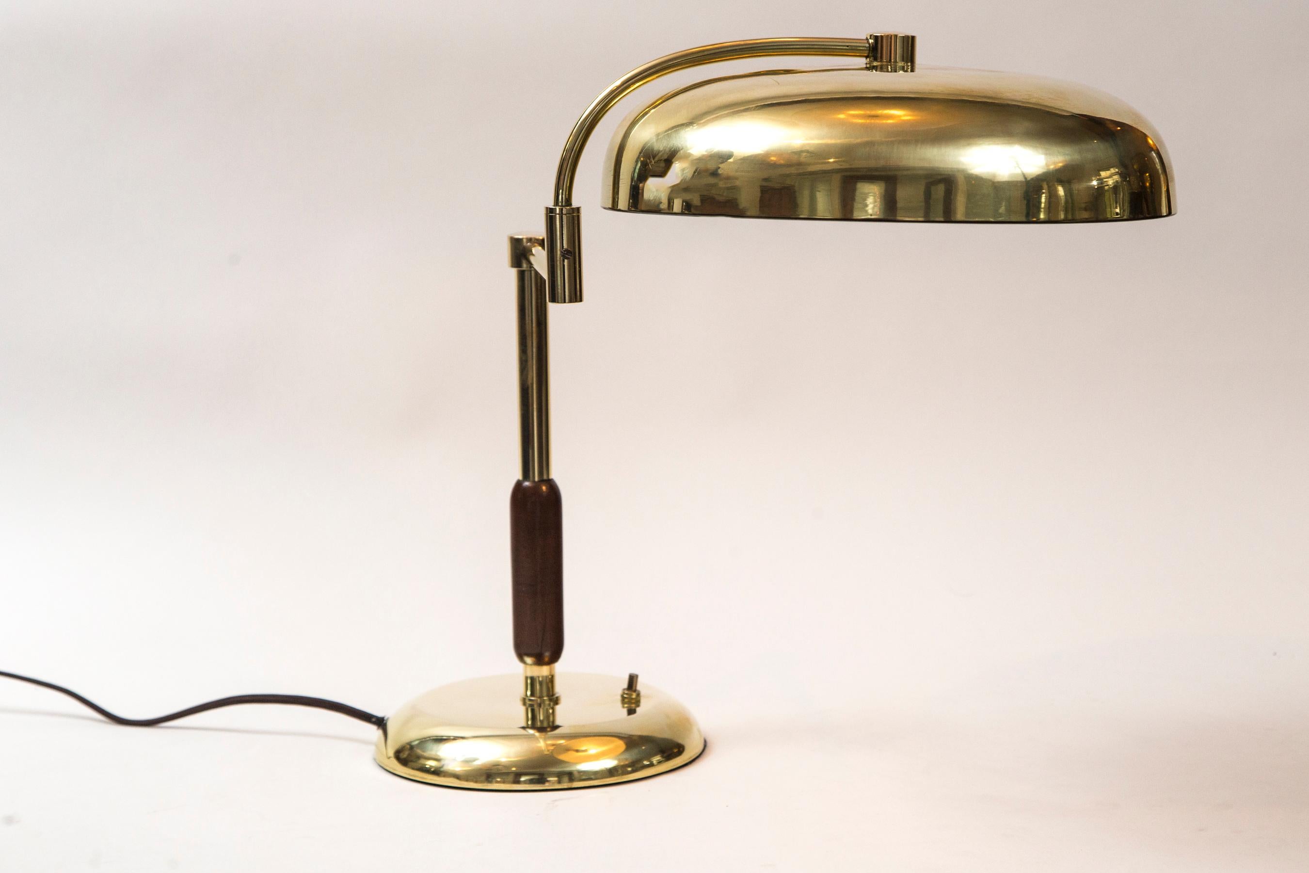 Large vintage unlacquered brass lamp with reticulating arm and shade designed by La Maison Desny
Ingenious folding function of the lamp inspired lighting designers into the midcentury
Very heavy lamp as base is weighted.

Condition: Excellent,