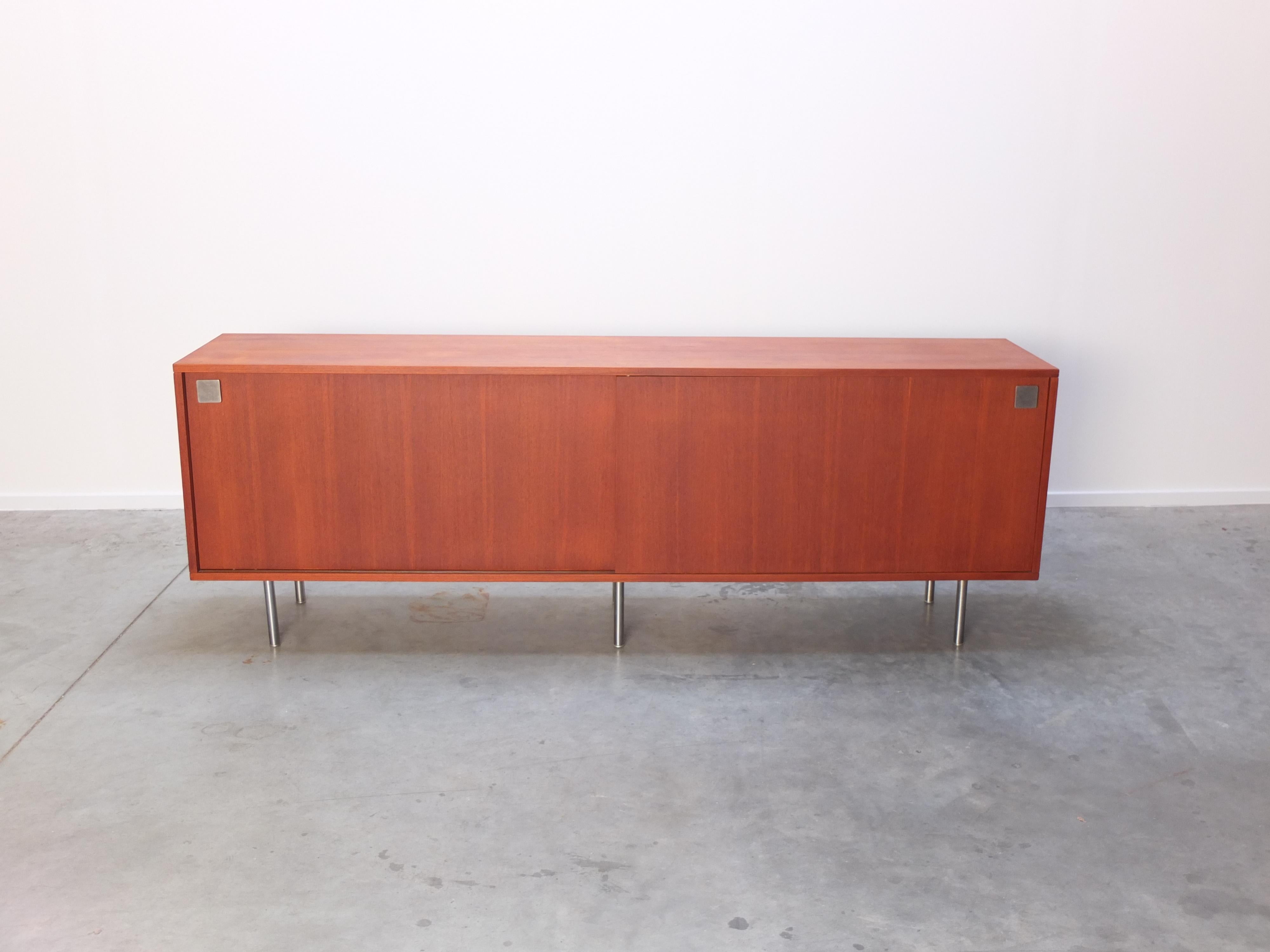 Large minimalist sideboard designed by Alfred Hendrickx and produced in Belgium by Belform during the 1960s. Made of teak wood with metal door handles and not so common metal circular legs. This sideboard can also be mounted to the wall for an even