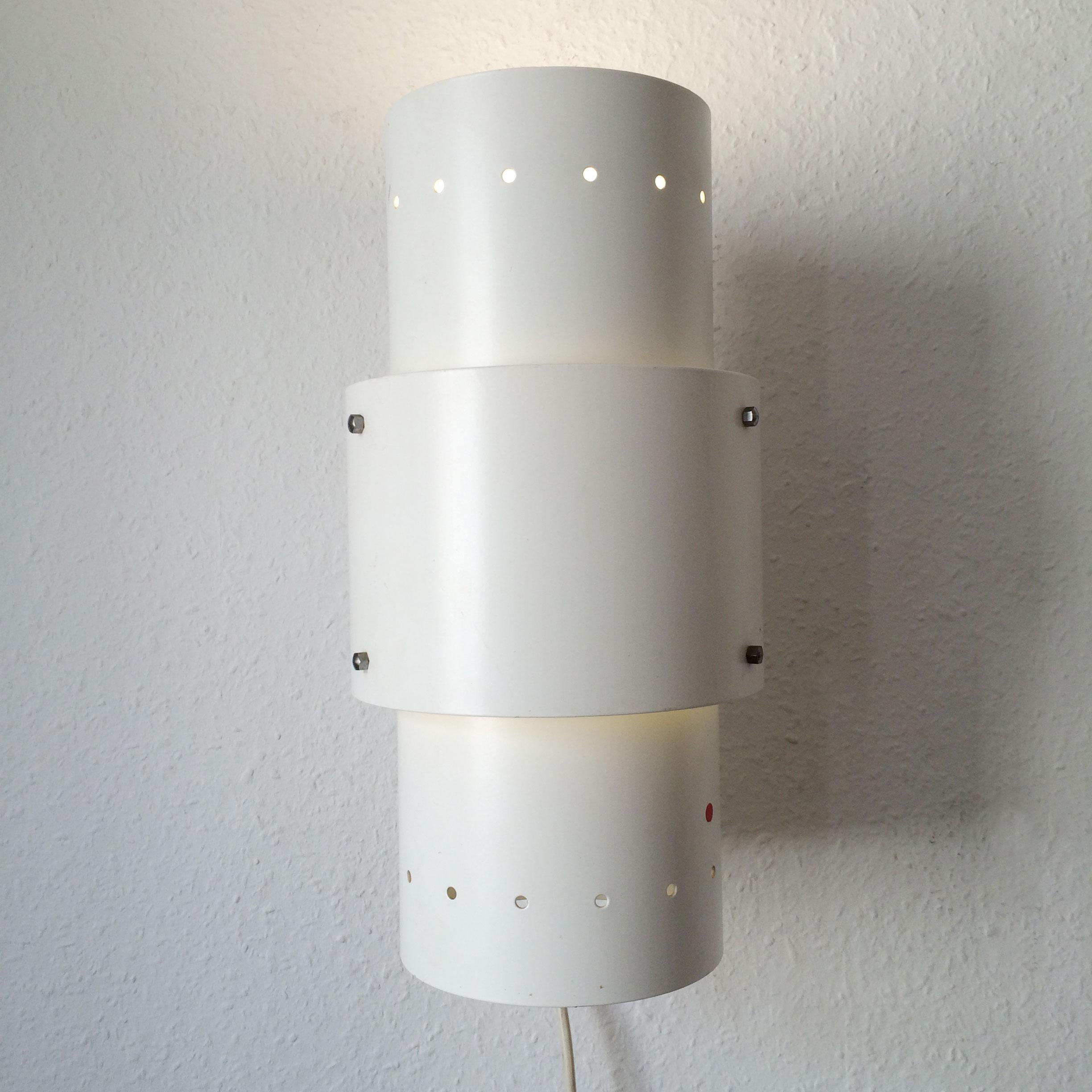 Monumental Mid-Century Modern wall lamp or sconce by Spectral, Freiburg, Germany, circa 1980s.
Executed in thick, perforated and white lacquered metal.

A total of 43 identical wall lamps / sconces available!

Each lamp needs 2x 10/13W PLC 230V 50