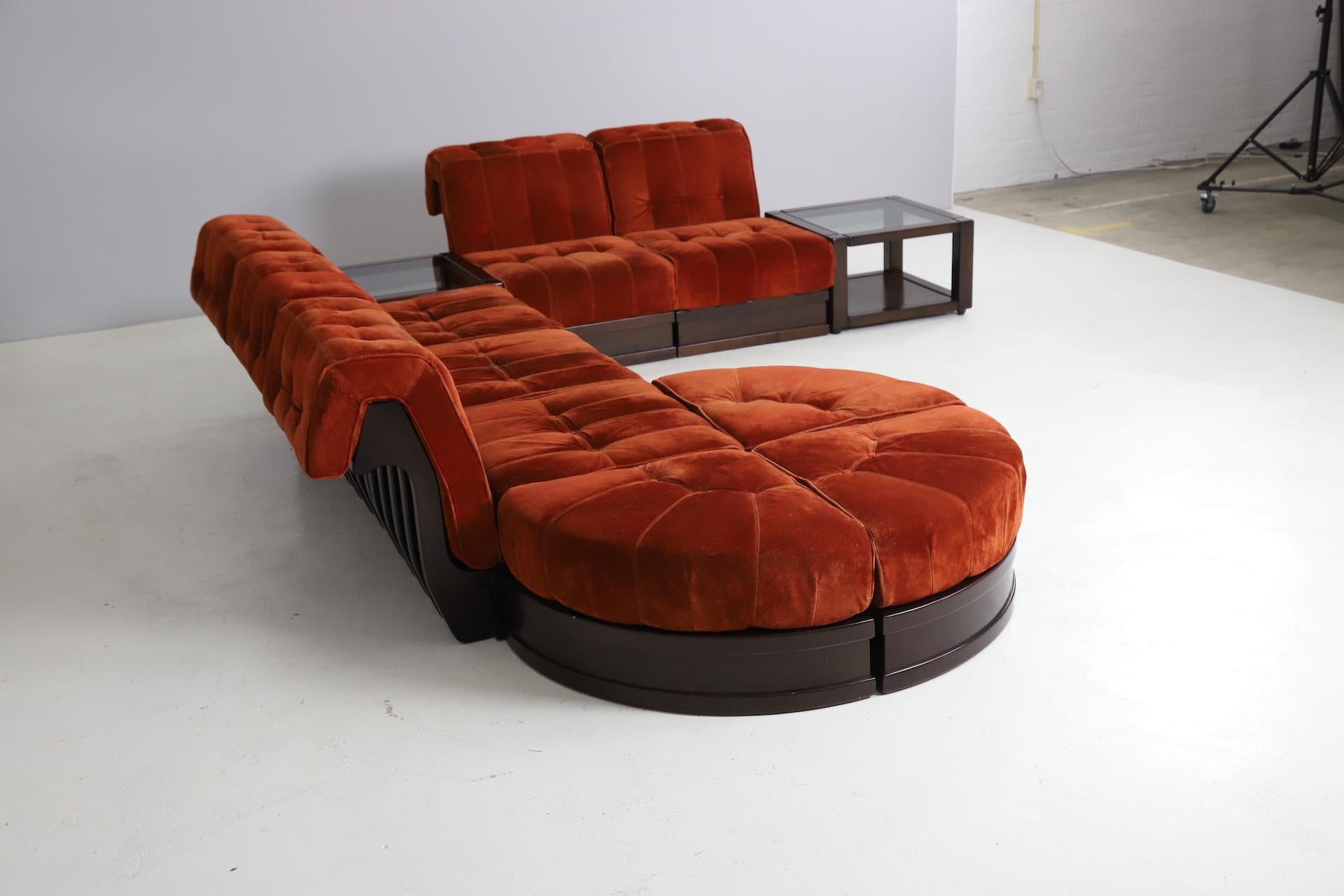 Large modular sofa model 'Can Can' designed by Luciano Frigerio. Original suede upholstery in a vibrant red colour on a solid mahogany frame. This modular sofa consists out 10 modular elements that be rearranged to fit in every room. 
The sofa still