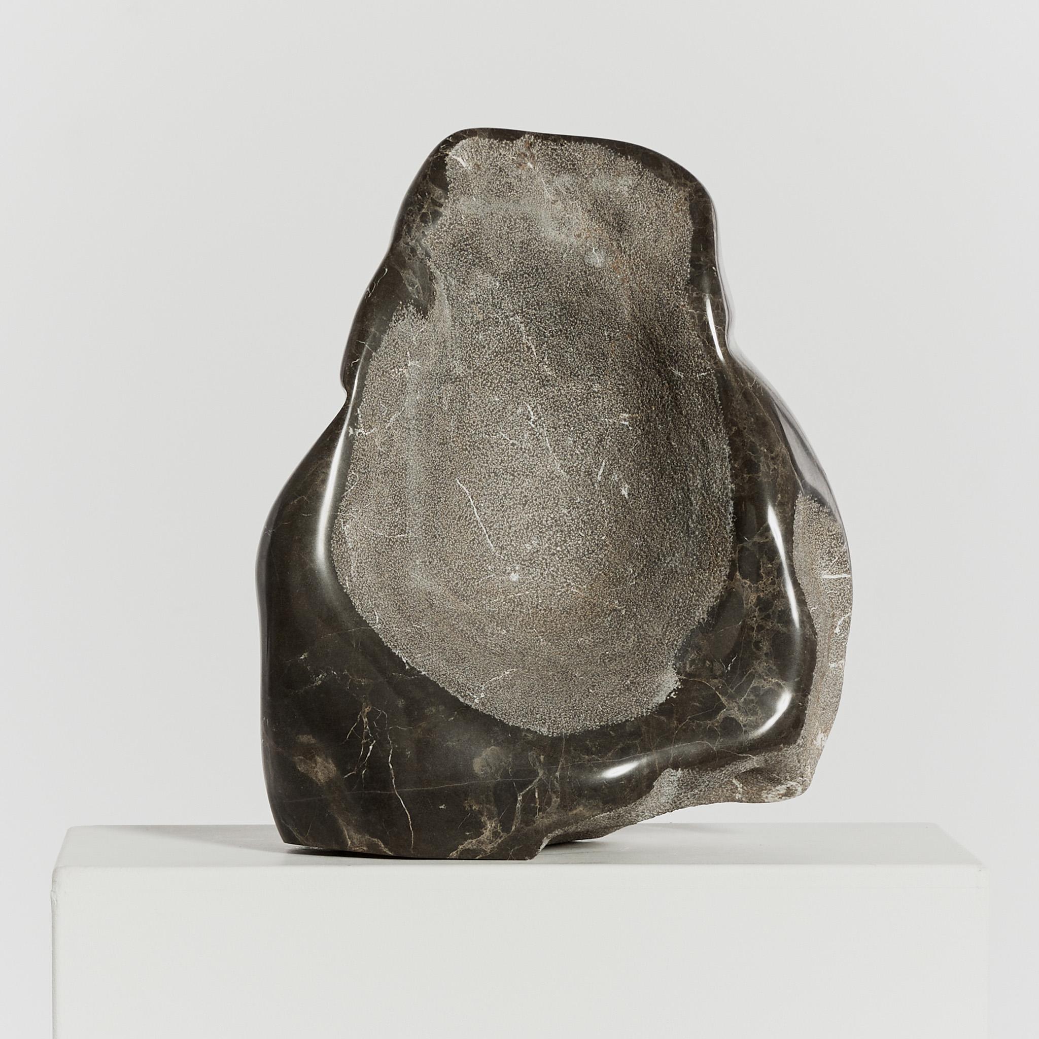 A hand carved abstract sculpture in Mokra limestone, signed by the late sculptor Michel Hoppe (1939-2002). The significantly proportioned balancing freeform piece features textural stippled detail and a contrasting velvety polished finish.