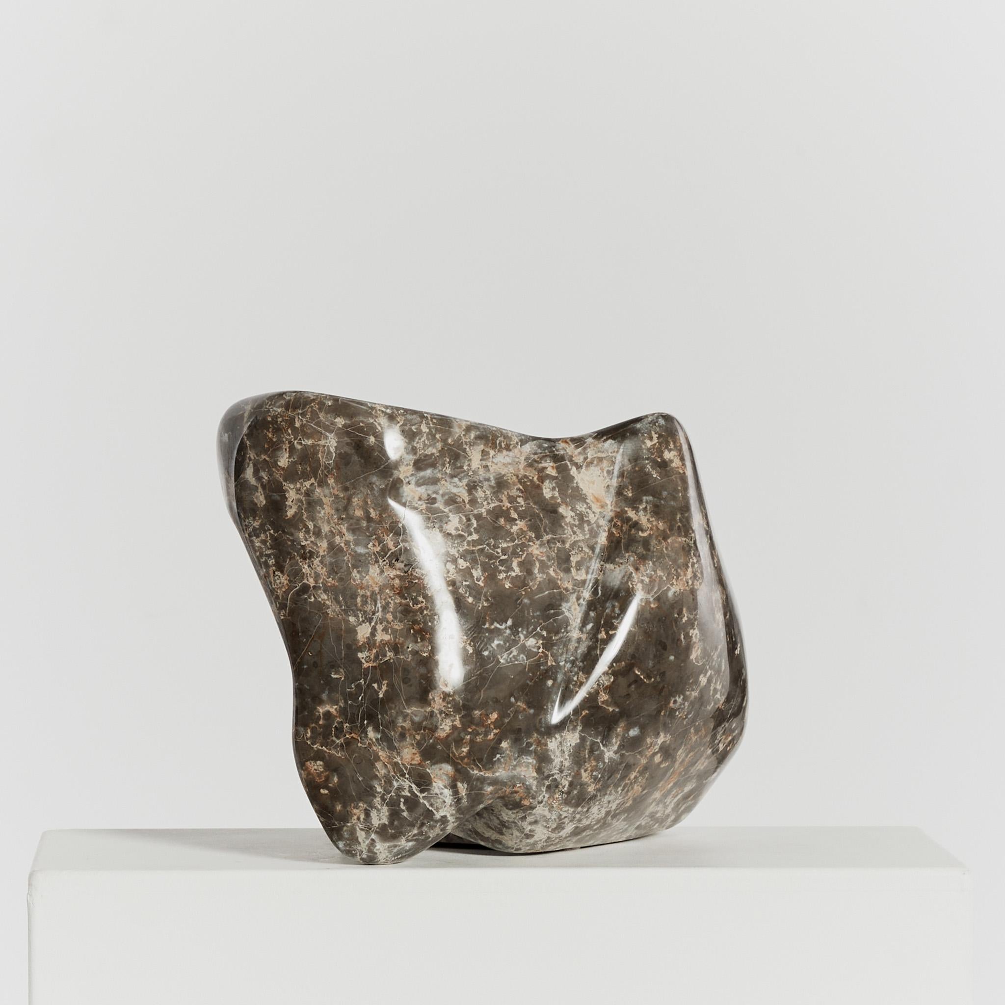 A hand carved abstract sculpture in Mokra limestone, signed by the late sculptor Michel Hoppe (1939-2002). The significantly proportioned balancing freeform piece features textural stippled detail and a contrasting velvety polished finish.