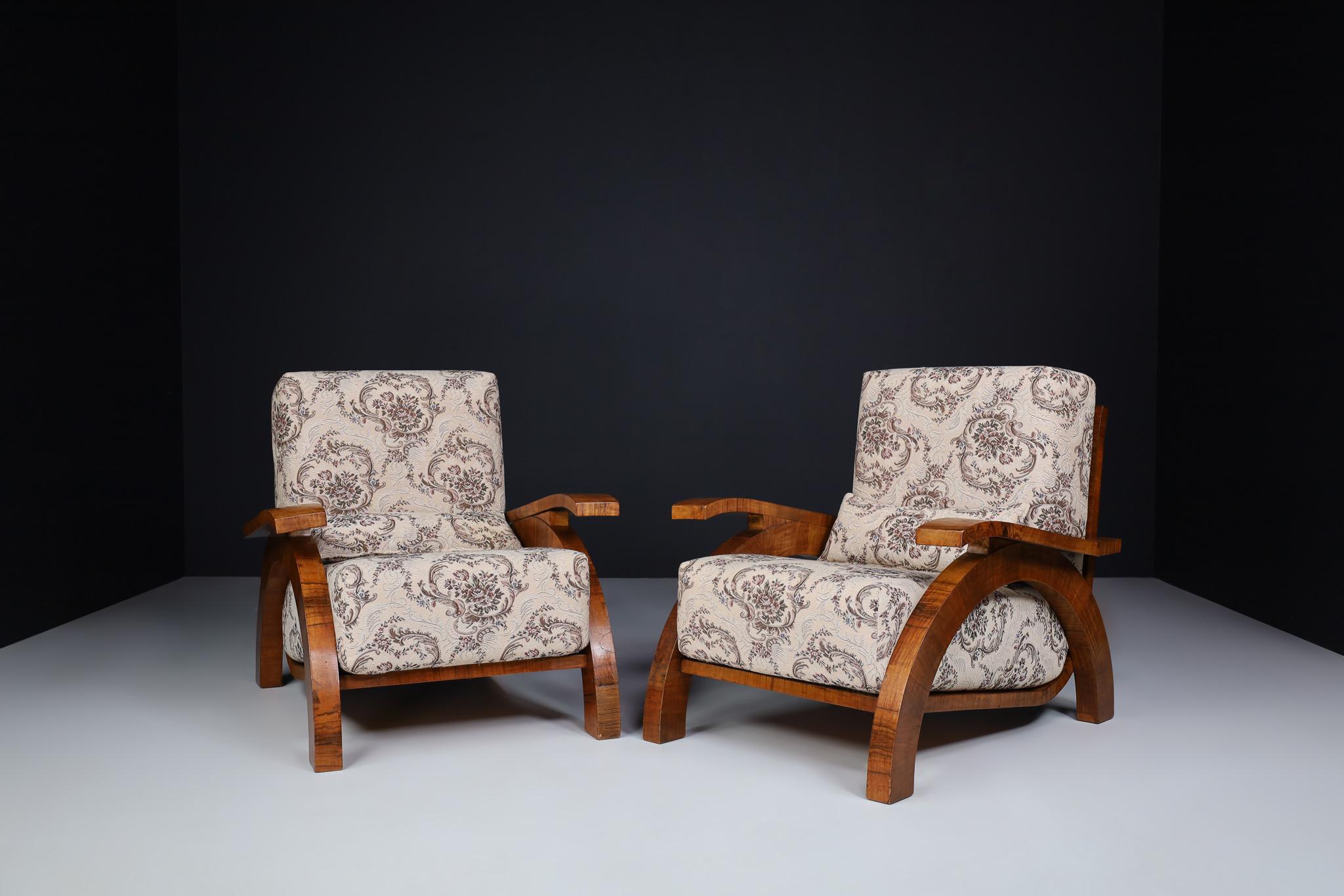 Large Monumental Art Deco armchairs in Walnut and Original Fabric, Prague 1930s

Set of two Large monumental Art Deco armchairs in walnut and original fabric in good vintage condition, Czech Republic 1930s. These monumental Xl size armchairs -