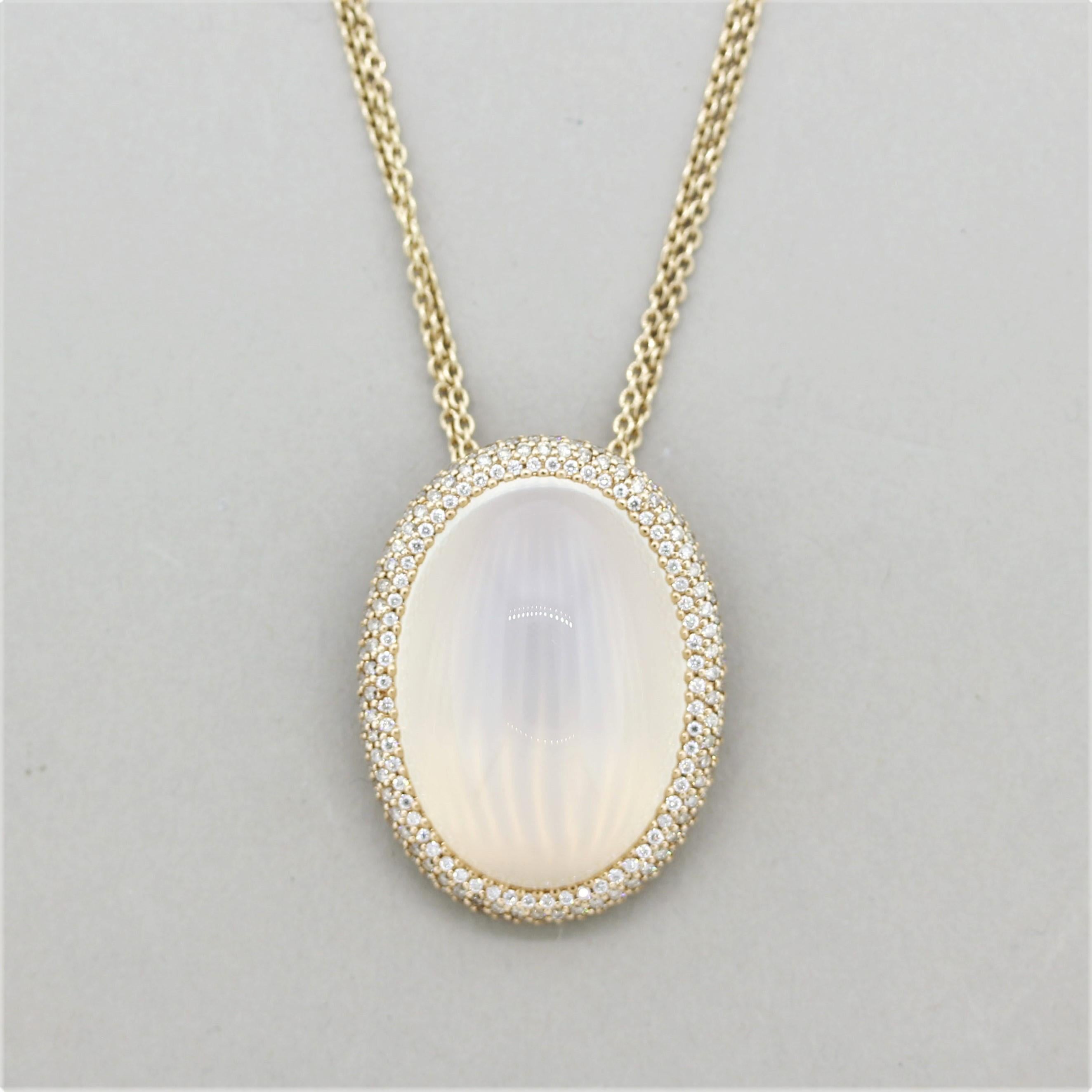 A large and impressive pendant featuring a 54.40 carat moonstone! It has a light and soft cream color that glows in the light. It is accented by 2.62 carats of round brilliant-cut diamonds set around the moonstone. Made in 18k rose gold and comes