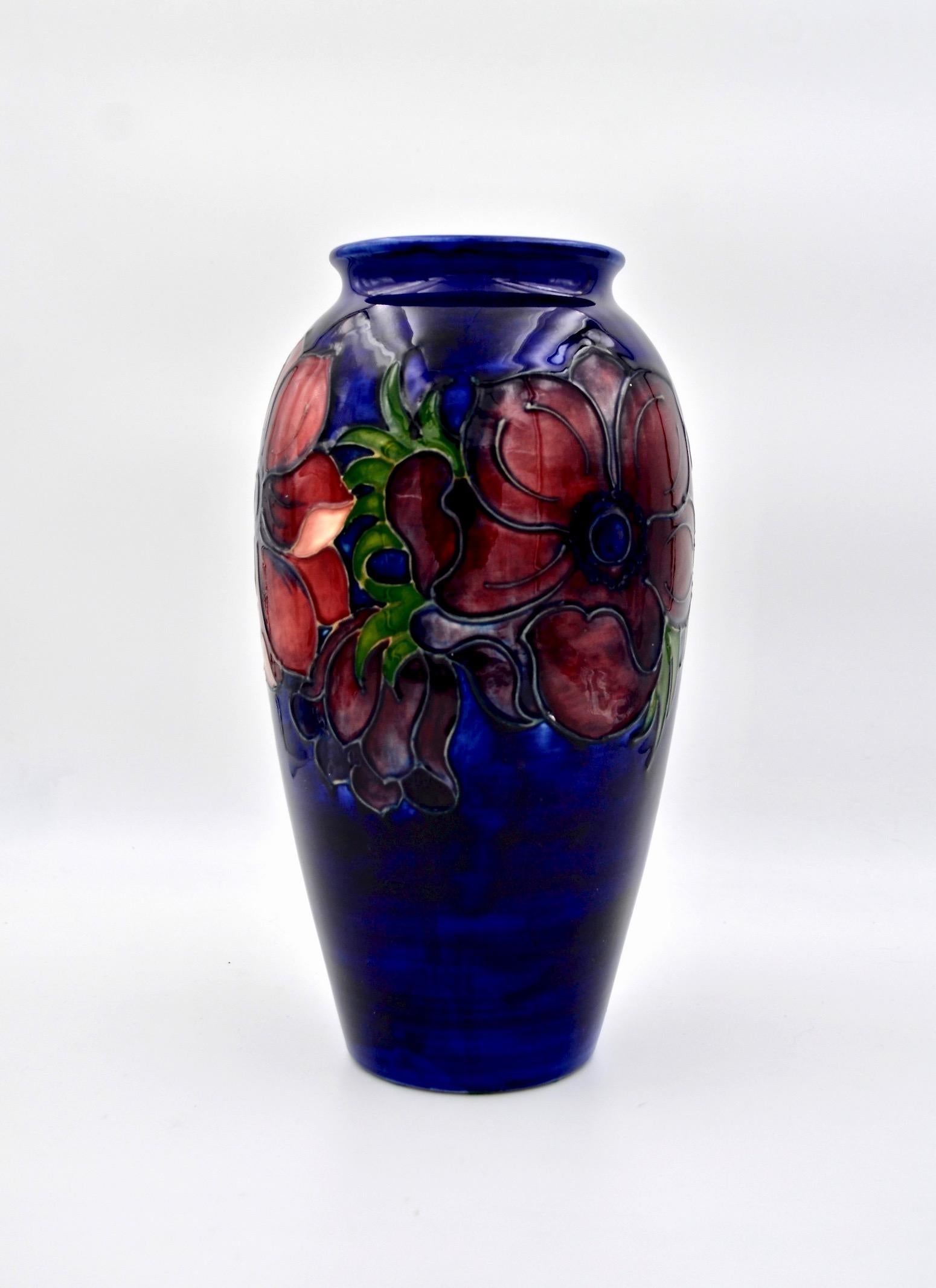 A large Moorcroft art pottery vase made at Stoke-on-Trent, Staffordshire, England and produced in a limited edition. The baluster-shaped vintage vase is decorated in the Anemone pattern featuring colorful tube-lined flowers in shades of maroon,
