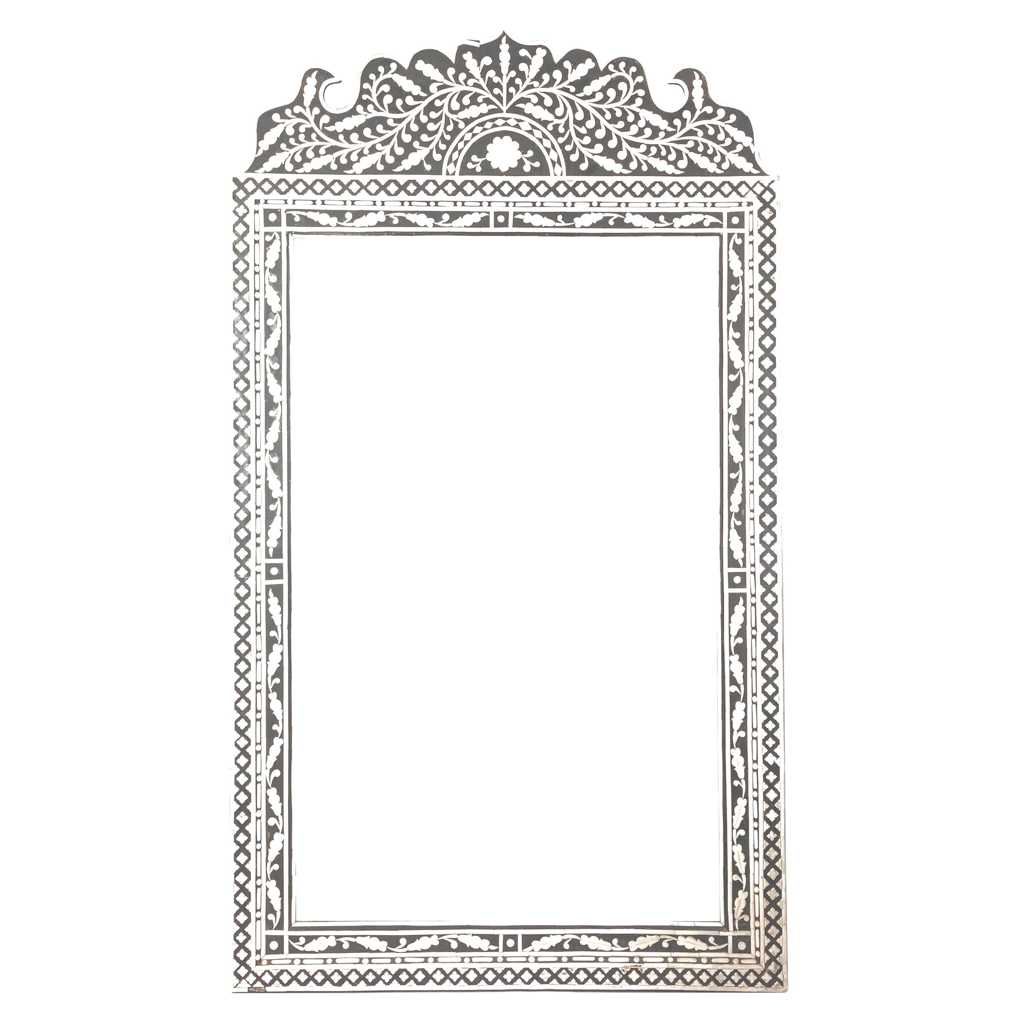 Large Moorish Style Bone Inlaid Wall Mirror. Mirror features sophisticated artistry and craftsmanship. Mirror has floral and fauna white bone inlay frame that makes a striking visual contrast to the underlying black. This style is rooted in rich