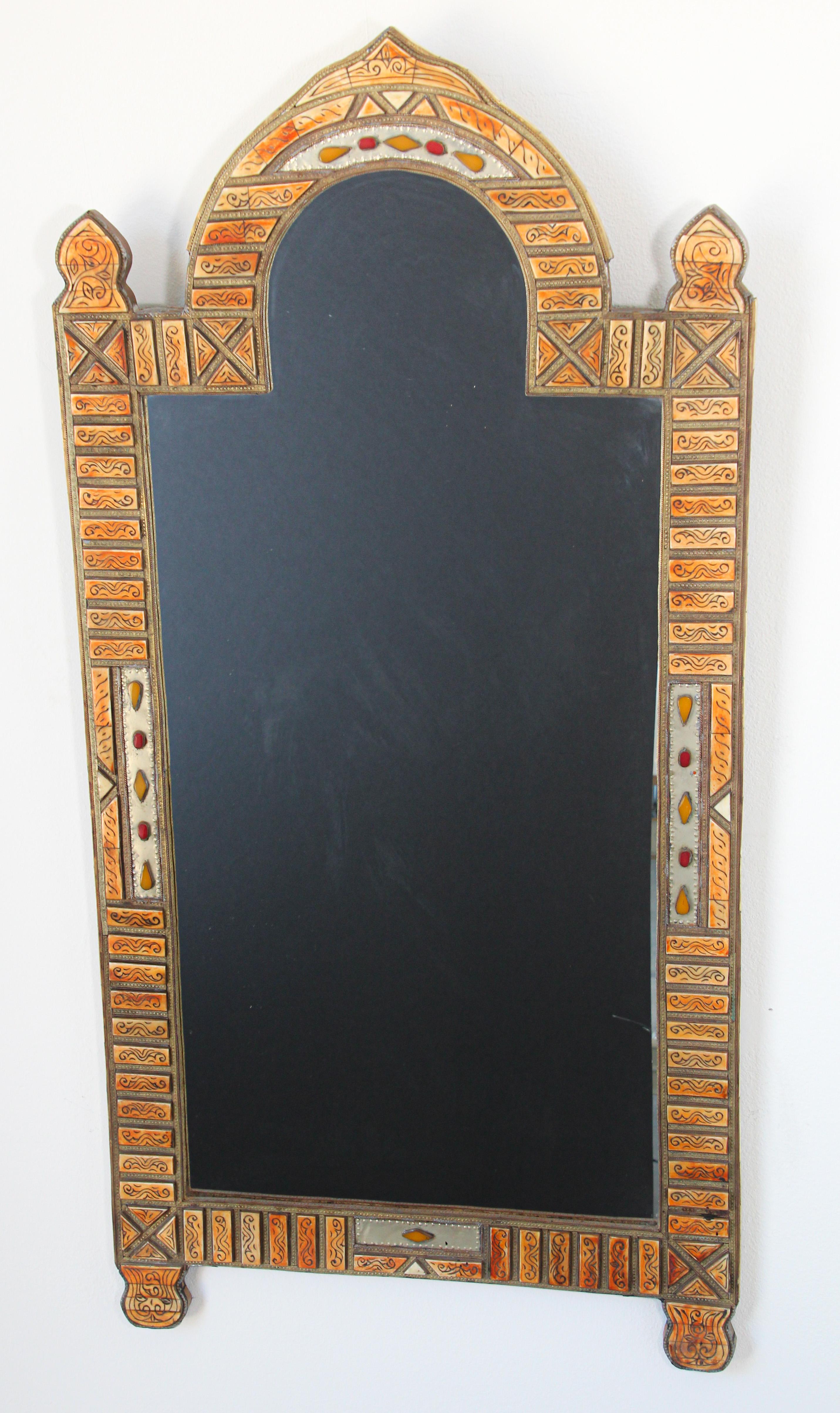 Large Moroccan mirror with brass embossed metal.
Vintage Moroccan handcrafted inly bone and brass arched Moorish mirror.
Moroccan mirror inlaid with carved recycled bone and brass embossed metal, intricately worked with classic elements of Moorish
