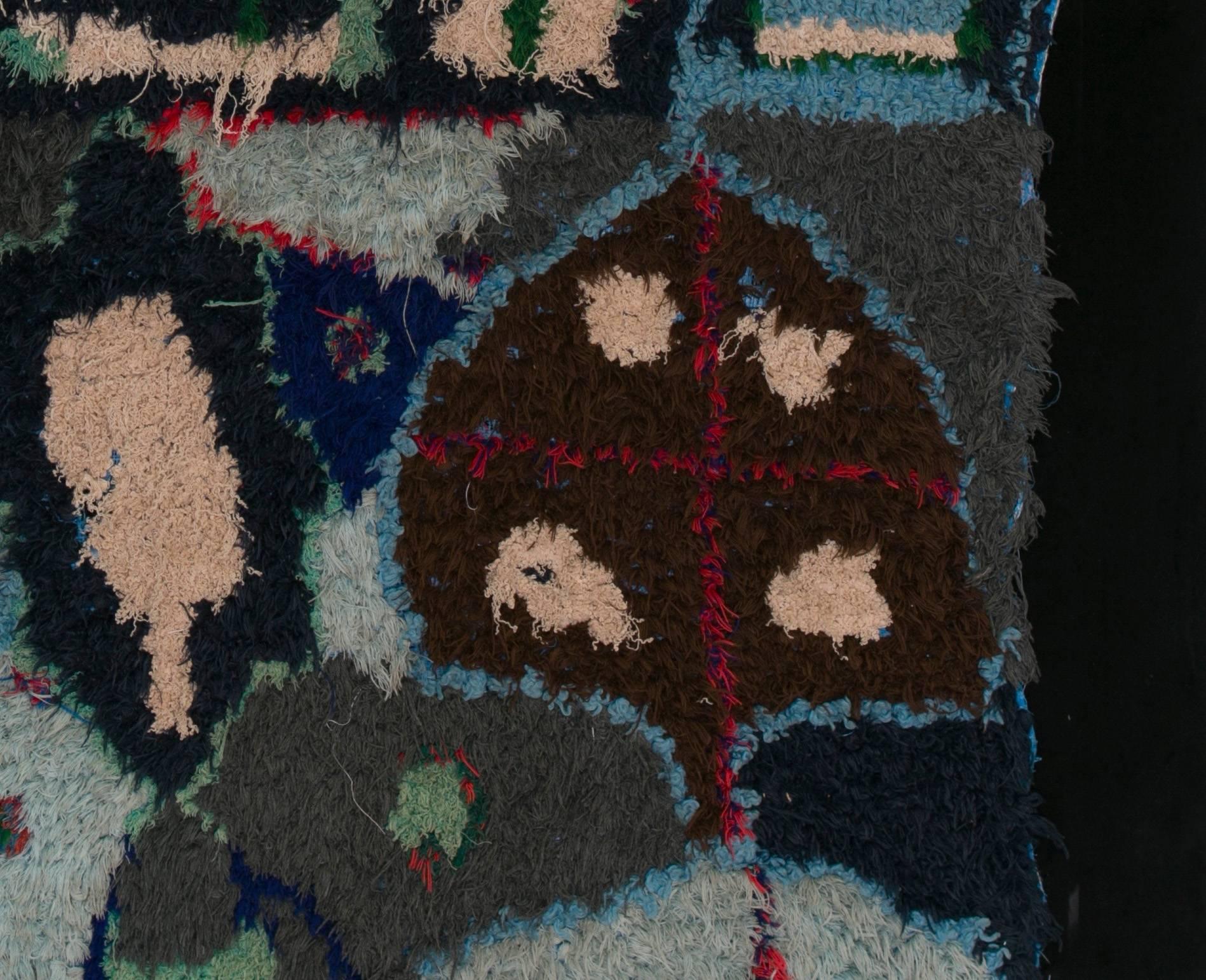 Tapestry made by Berber women from the Atlas Mountains.

This unique and vintage work is made of embroidered woolen ends on wasted grain bags. 

The patterns and harmony of the blue colors are amazing when we refer to the conditions and the