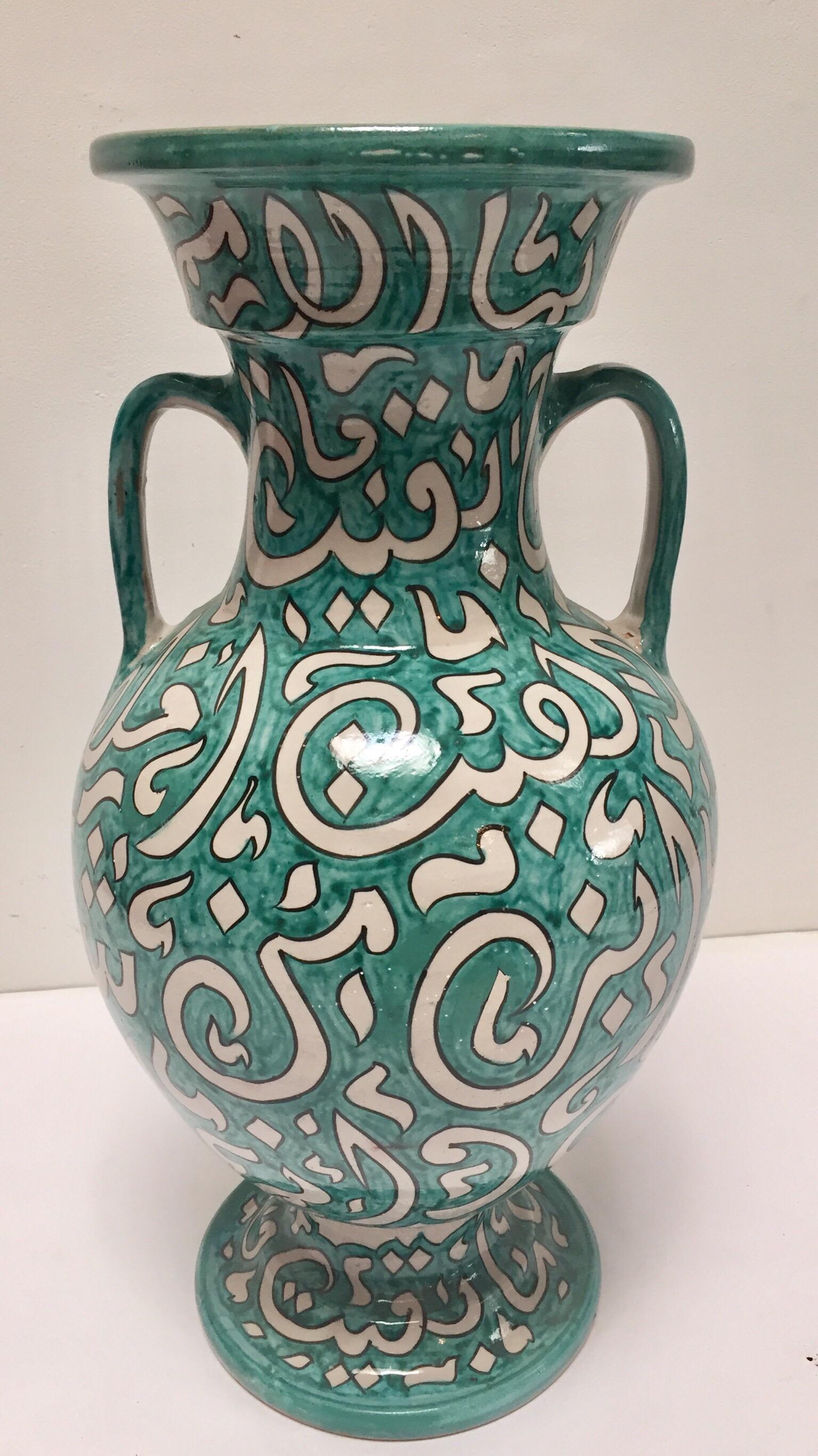 Large Moroccan glazed ceramic vase from Fez.
Moorish style ceramic handcrafted and hand painted with Arabic calligraphy writing.
This kind of Art Writing looks calligraphic is called Lettrism, it is a form of art that uses letters that are not