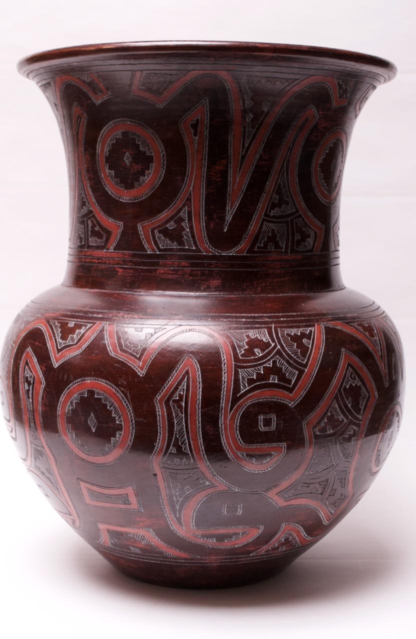 Monumental hand painted terracotta burgundy and pink vessel (circa 1970s Morocco) implementing sgraffito technique and tribal decoration. Very large in scale: circumference is 61.5