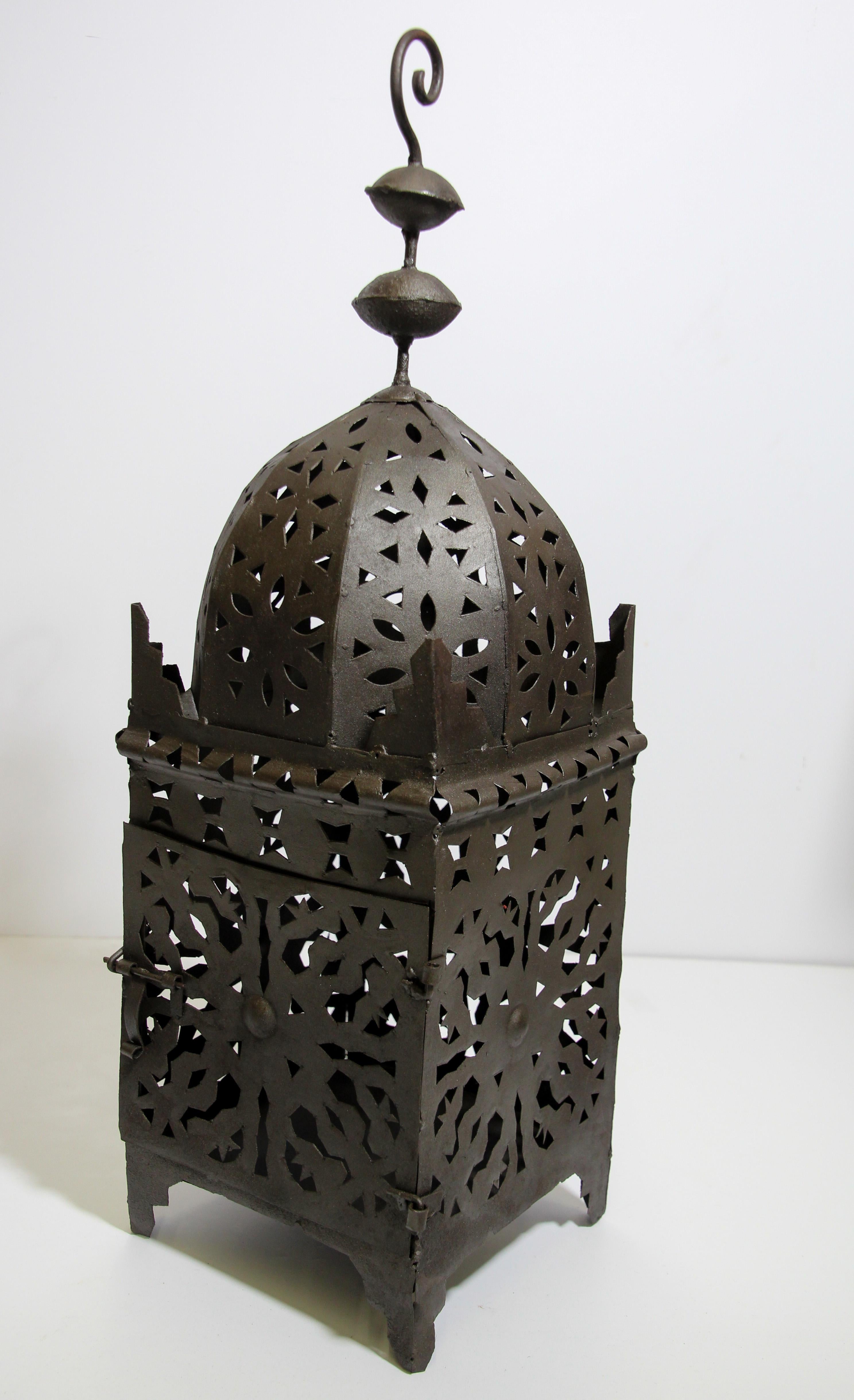 Large Moroccan Moorish metal candle lantern.
Incredible rough cut metal form, vaguely Spanish revival Moorish in outline but with a brutalist edge, reminiscent of the work of Felipe Derflinger.
Hurricane candle lamp handcrafted in Morocco by