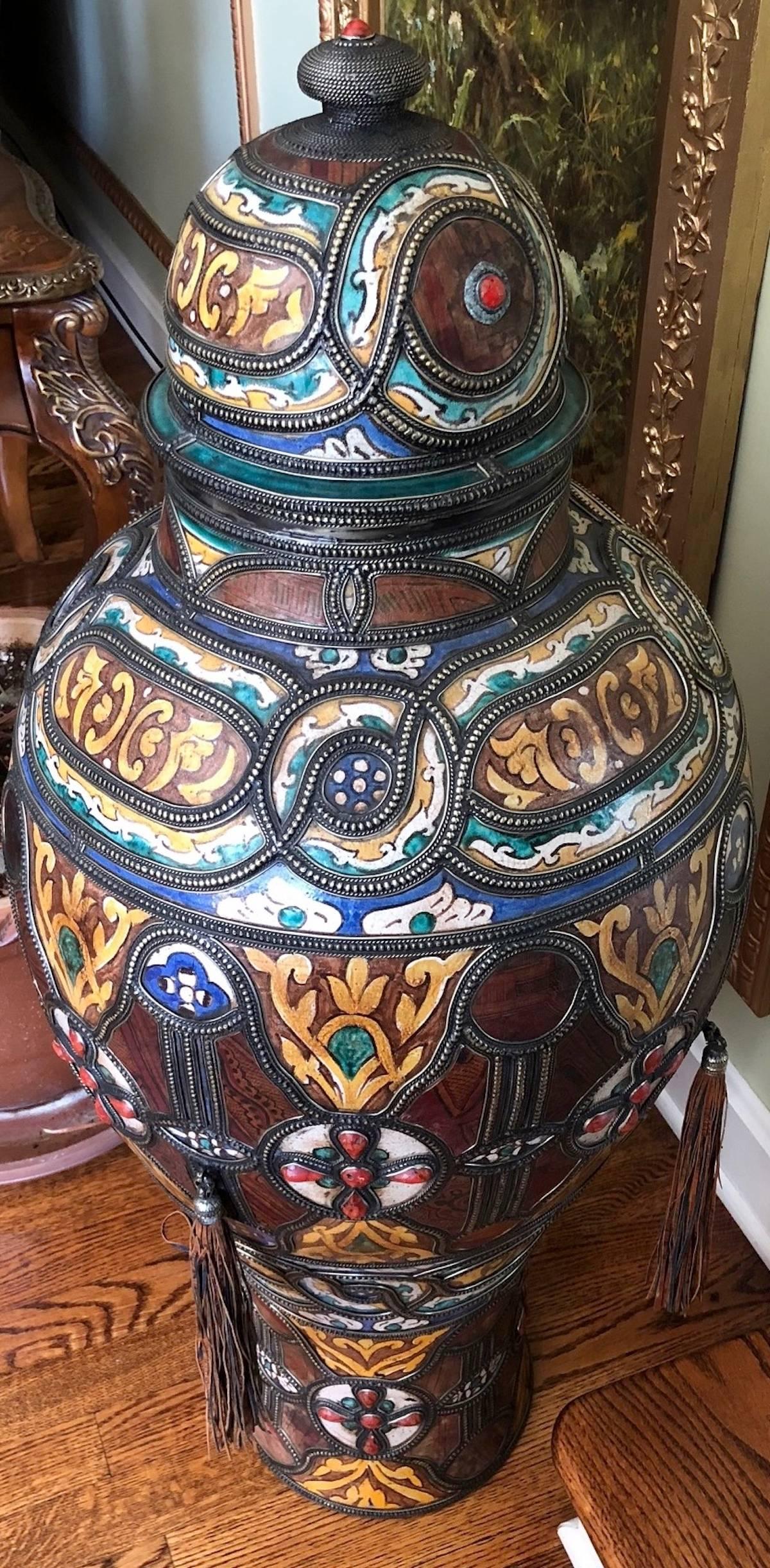 Large Moroccan porcelain and metal palace urn. One of two in this auction. Measures 40 inches in height.