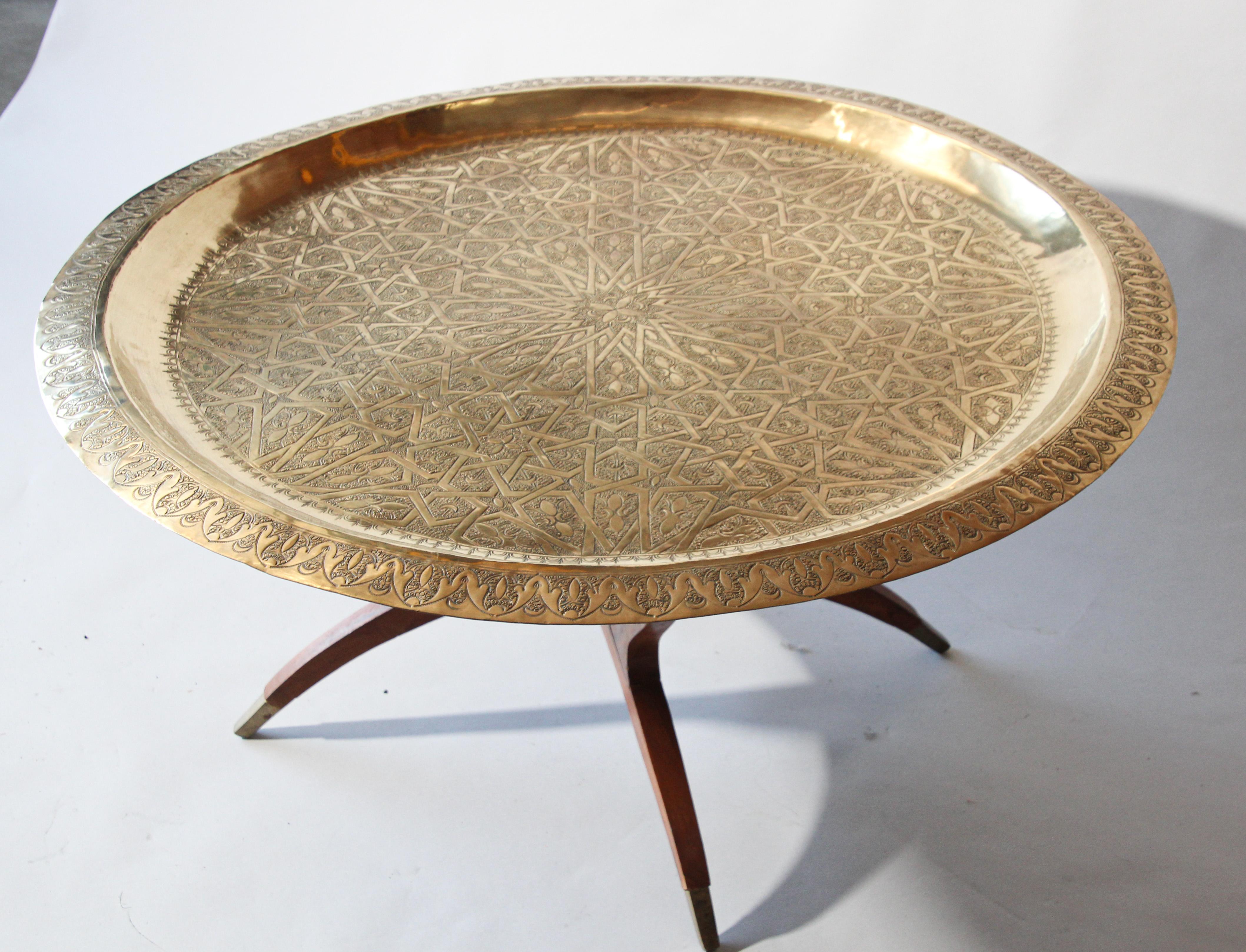 Engraved and embossed large 39 inches round midcentury Anglo-Indian brass tray table.
Polished brass Moroccan tray, very good condition, standing on folding mahogany base with six legs.
Large metal hand-hammered brass tray coffee table.
Middle