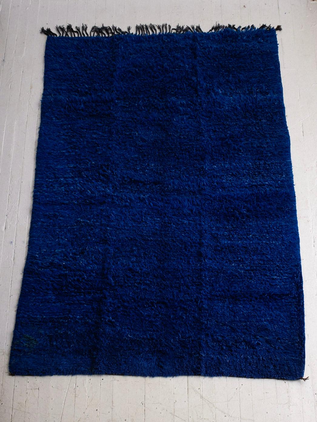 Large hand knotted Moroccan wool rug in cobalt blue. High pile shag. Color variations give dimension to the vivid shade of blue.