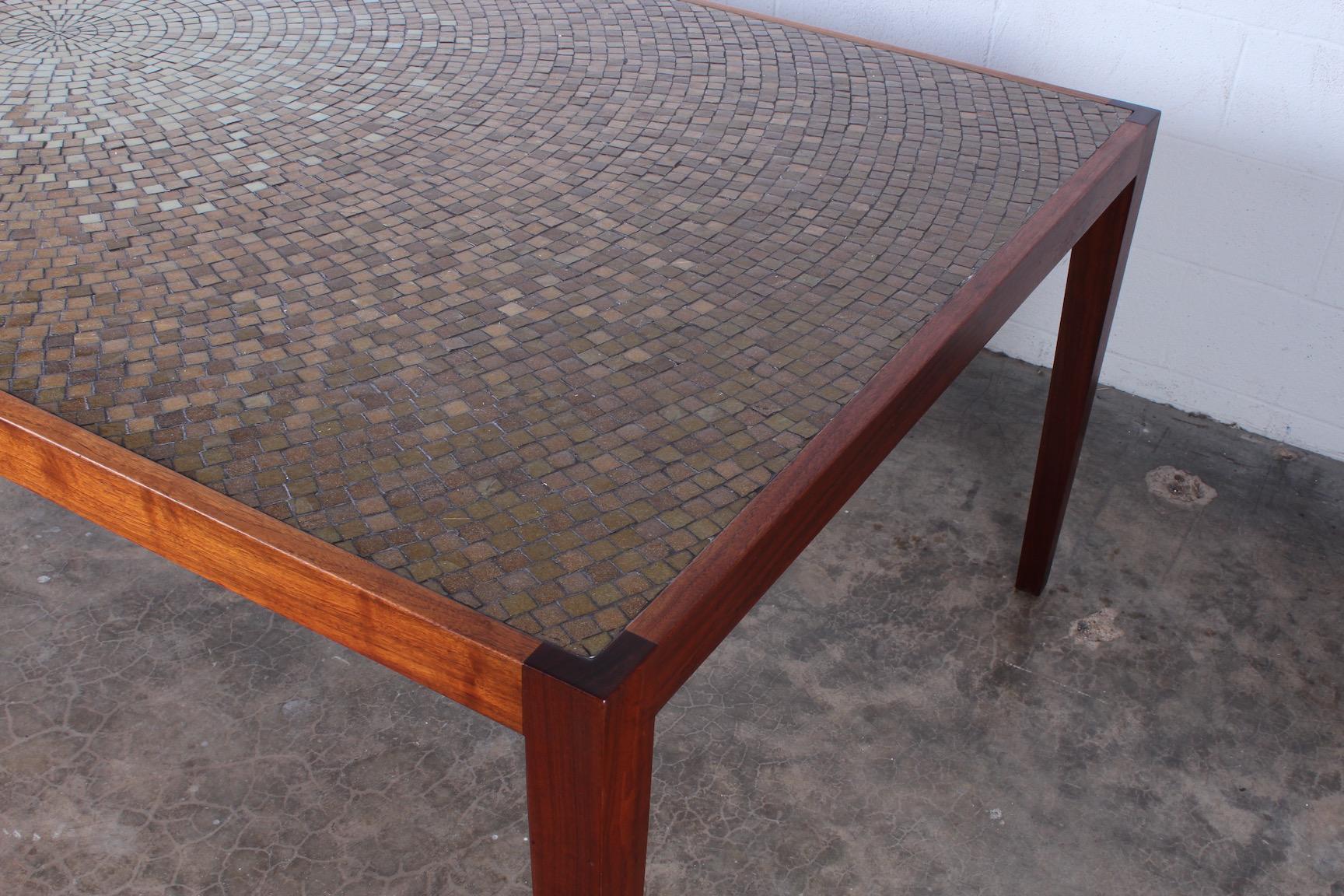 A large walnut dining table with Murano glass mosaic top. Custom-made by Harry Lunstead.