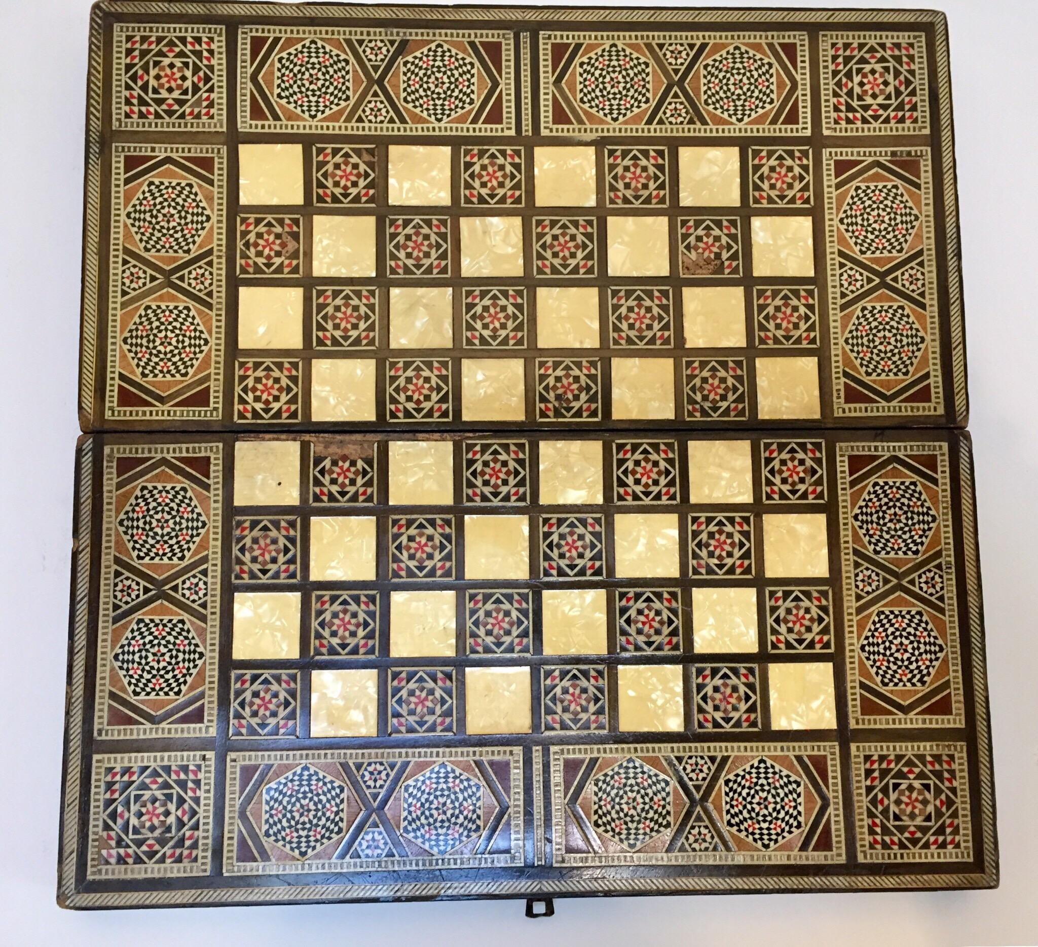 Large vintage Syrian inlaid marquetry mosaic backgammon and chess game box.
Amazing craftsmanship intricate marquetry in mosaic Moorish geometric pattern and mother-of-pearl inlay and fine precision makes it a true work of art.
Handcrafted in the
