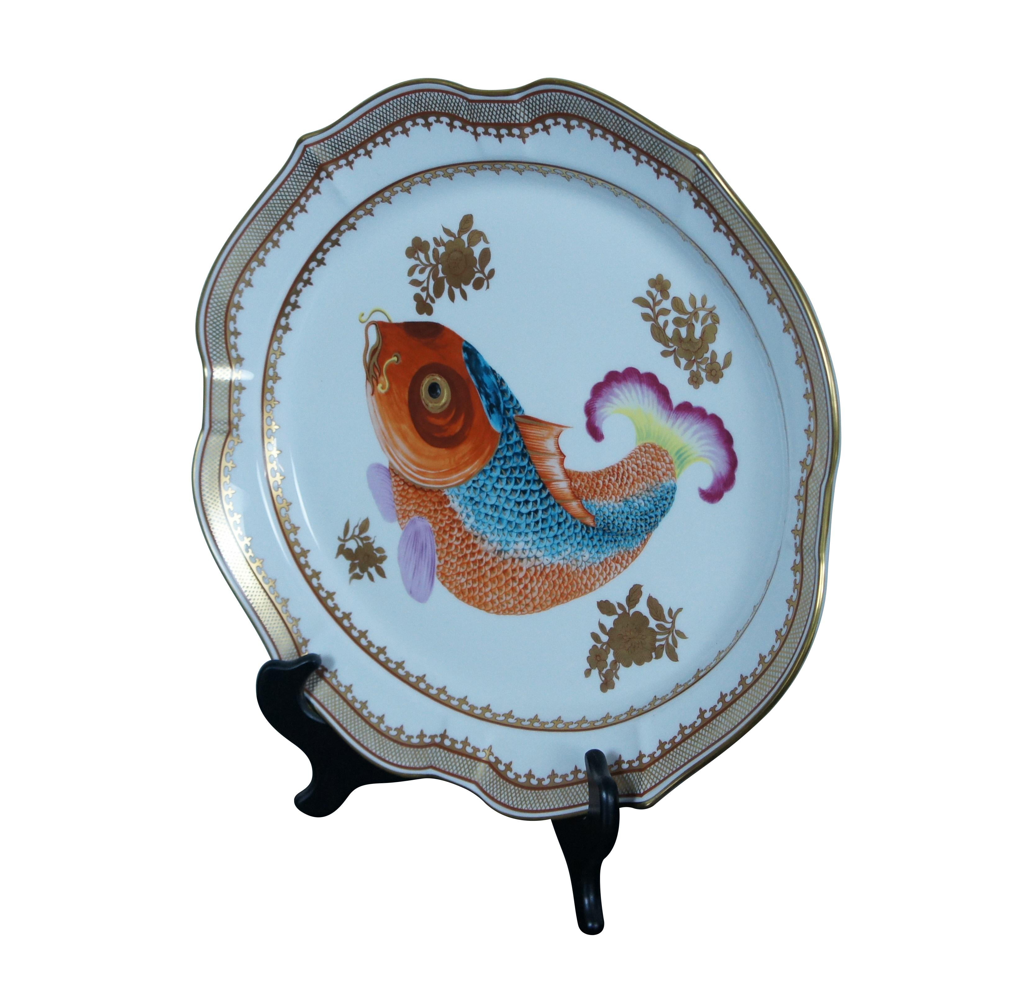 Large porcelain serving platter; oval with scalloped edges, painted / gilded border around gilt flowers and a brightly colored carp / koi / gold fish. 