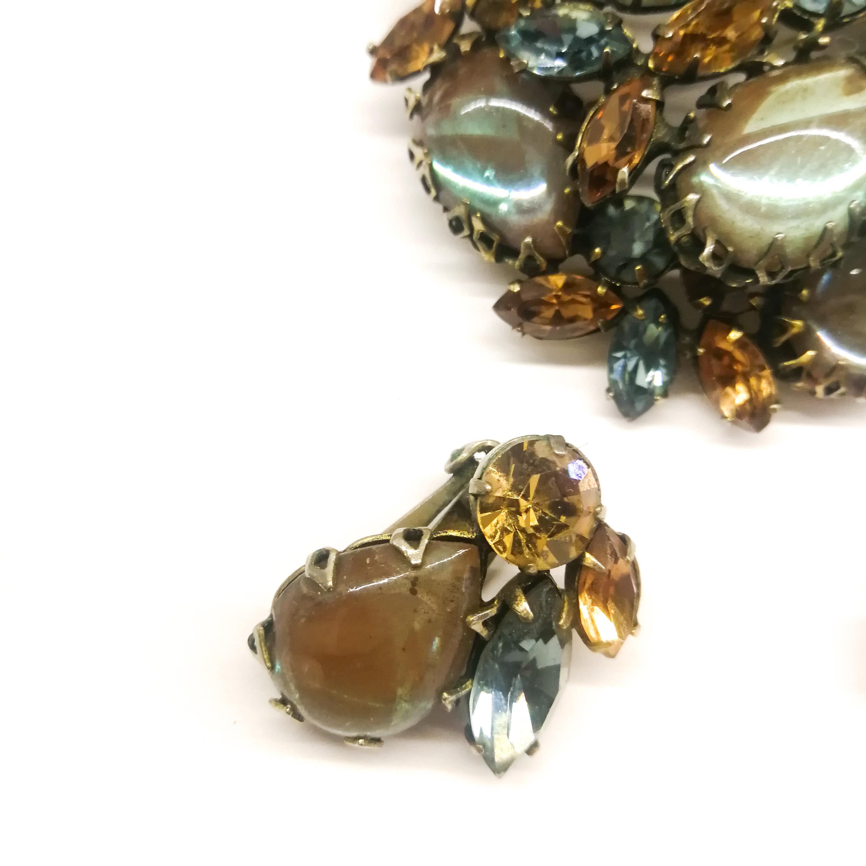A vintage brooch and earrings from the 1950s, with a very beautiful and subtle colour combination, including large cabuchons of 'sapphrite' glass, a highly sought after and collectable paste stone, magically changing from one colour to another, that
